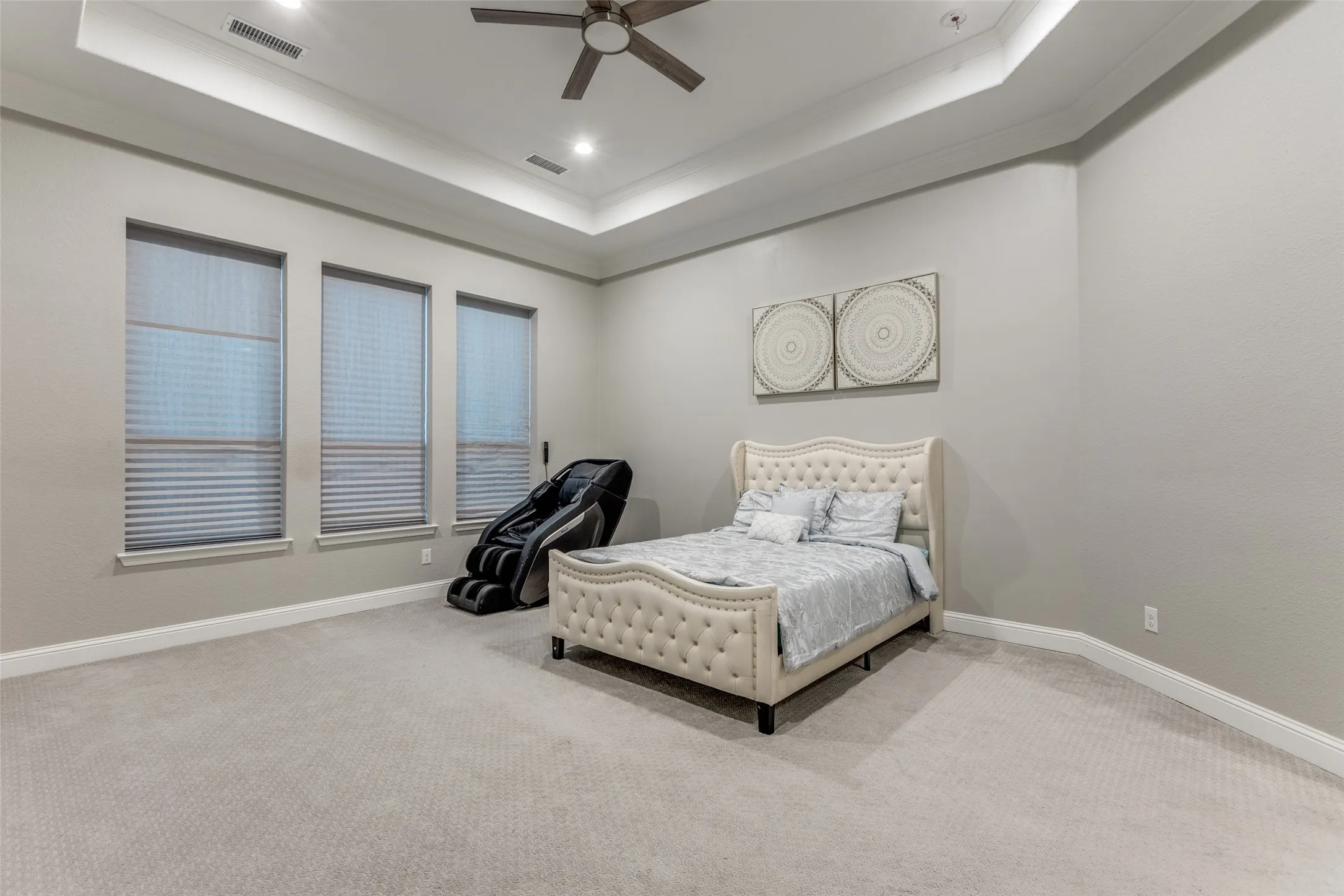 Spacious room with a neutral color palette, recessed lighting, and a contemporary ceiling fan