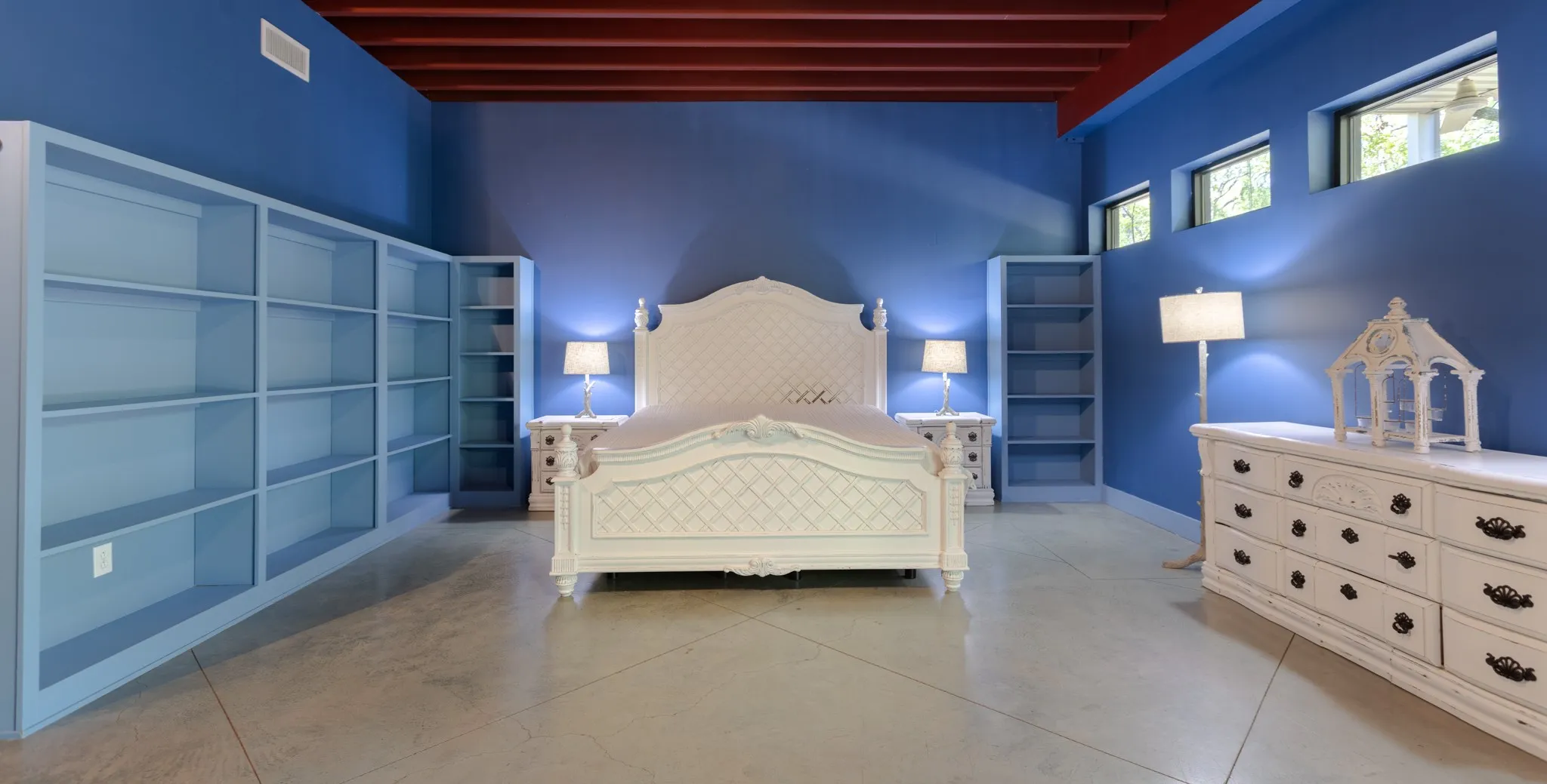 Primary bedroom with an abundance of open shelves for extra storage.