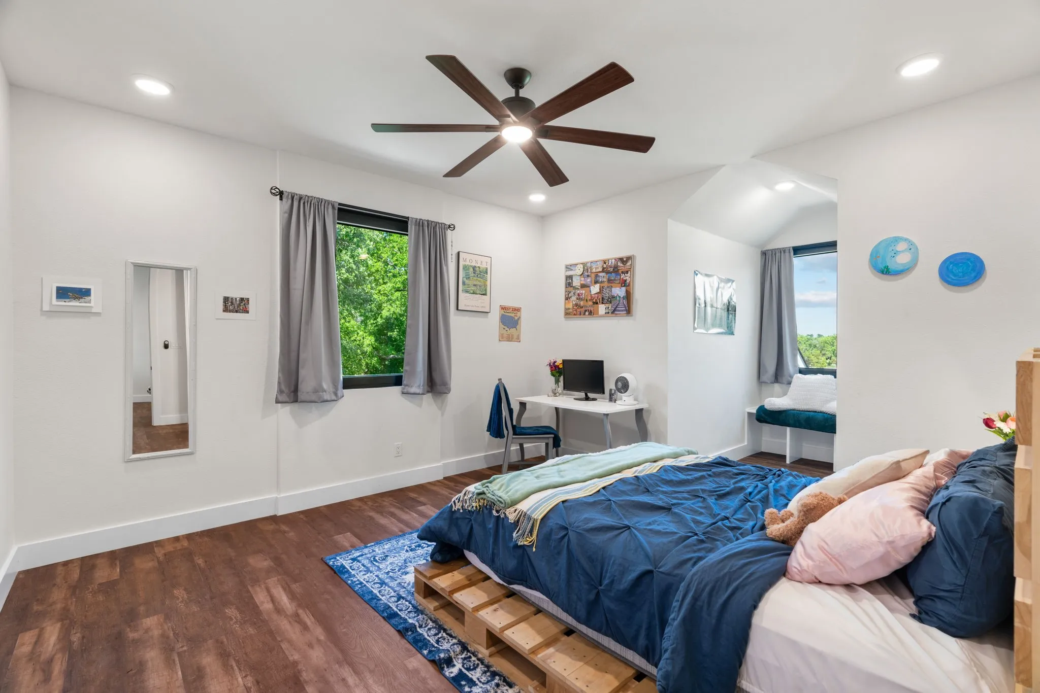 Spacious interior featuring wood-finish flooring, white walls, and recessed lighting