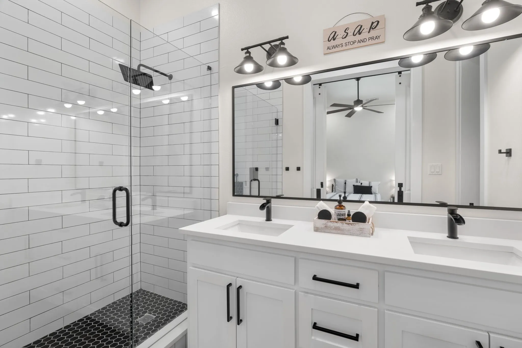 Double vanity with white cabinetry and integrated sinks, quartz countertop, and matte black hardware