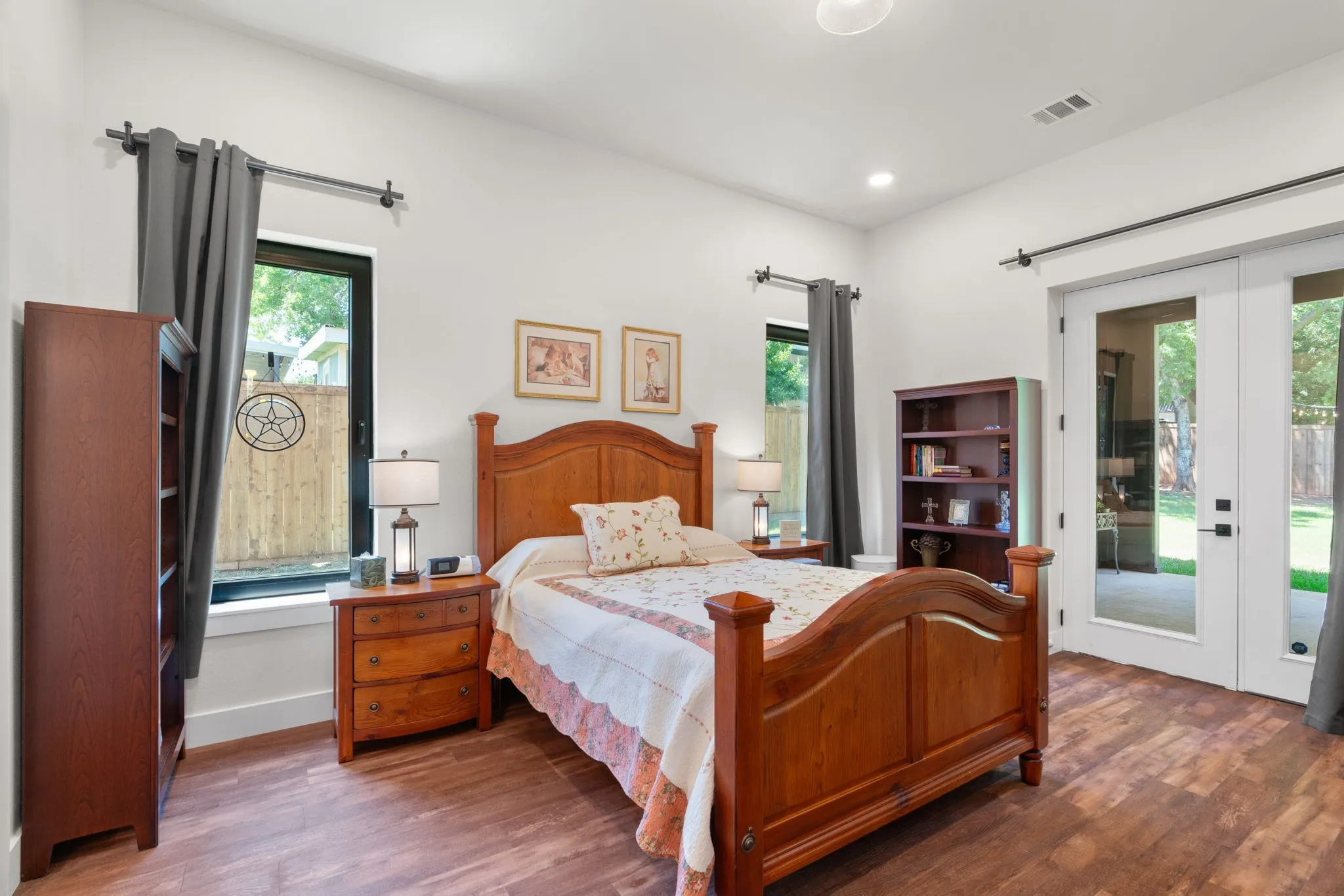 Wood-finish flooring with white walls and recessed lighting