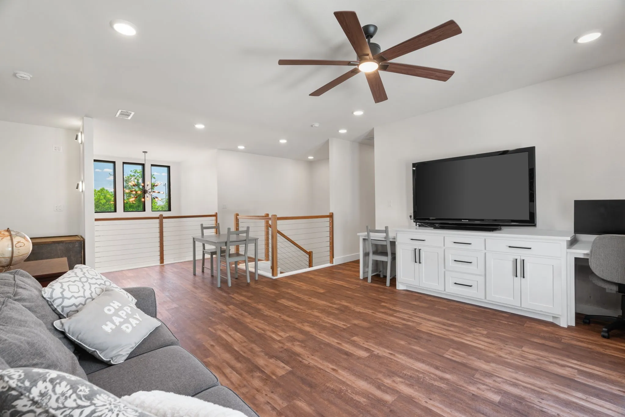 Open concept living area featuring wood-finish flooring, recessed lighting, and a modern ceiling fan