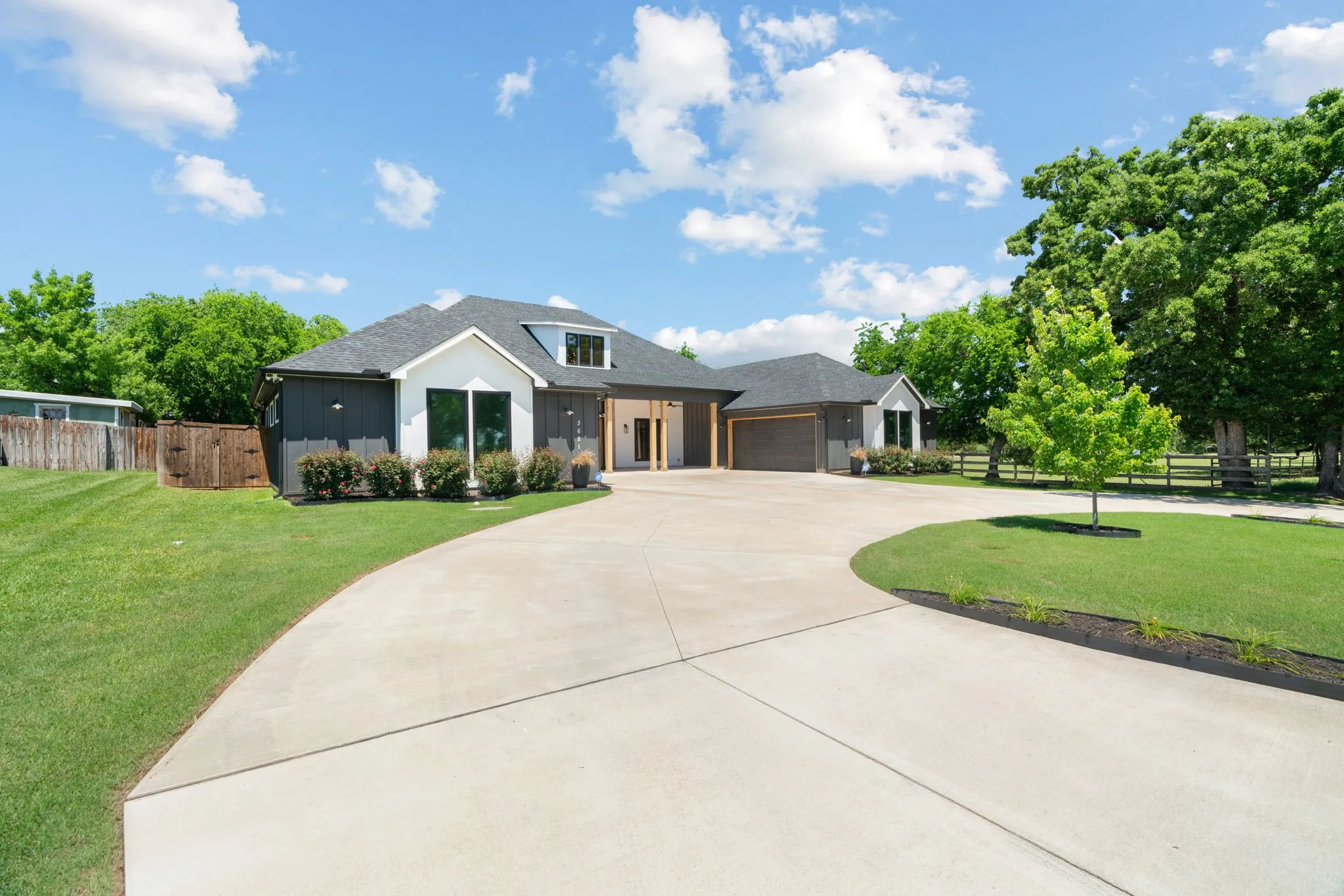 Circular concrete driveway with surrounding manicured lawn