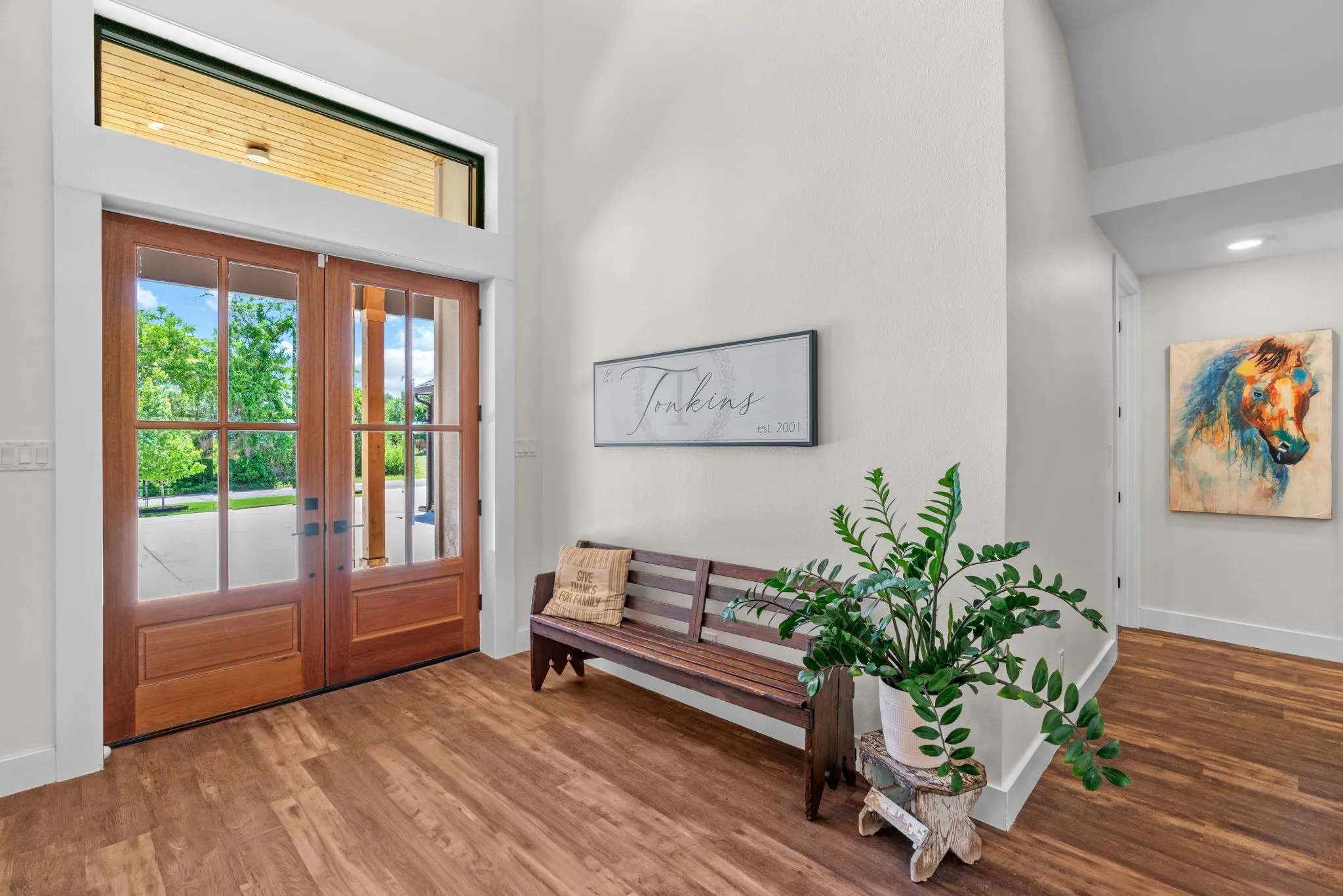 Double entry doors with glass panels and a transom window