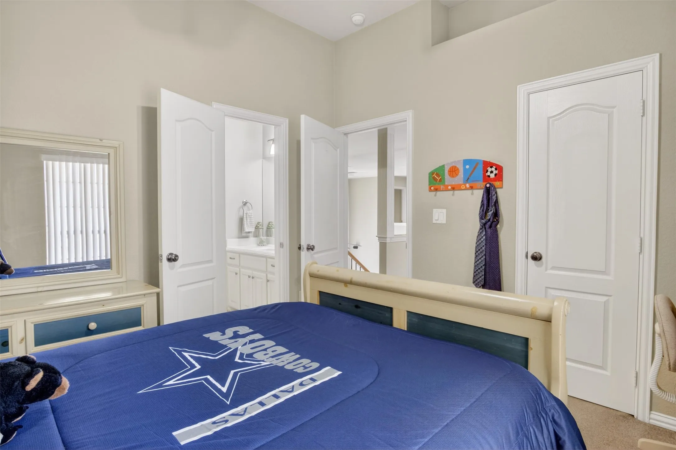 Bedroom featuring light-toned wall paint and an angled ceiling