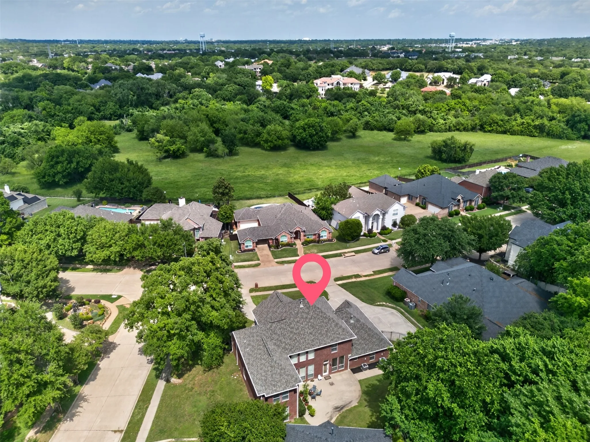 Aerial view of a residential neighborhood featuring established homes with dark shingle roofs