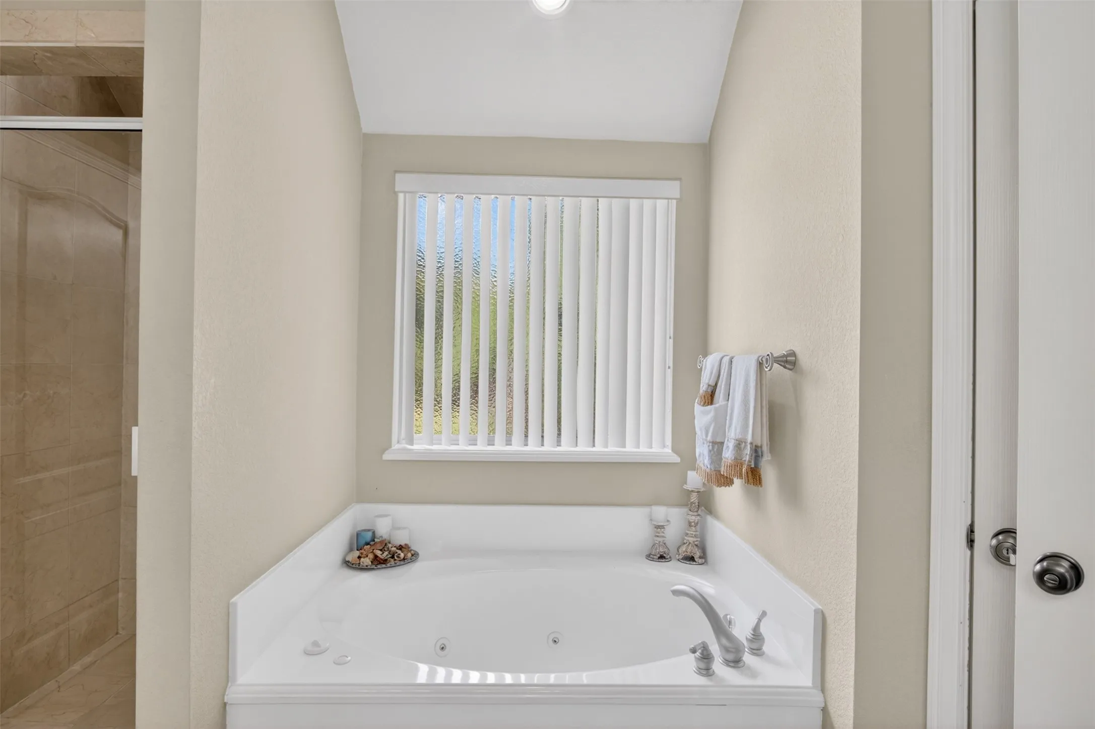 Built-in soaking tub with deck-mounted faucet and jetted features