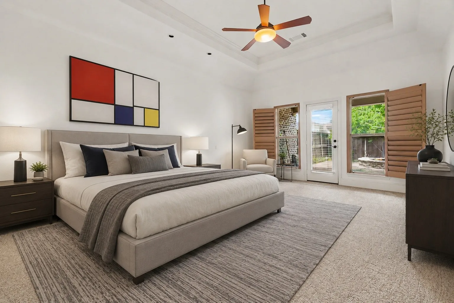 The primary bedroom is a true oasis with high ceilings, windows treated with louvered blinds, and a private entry-exit to the covered patio by the pool.
