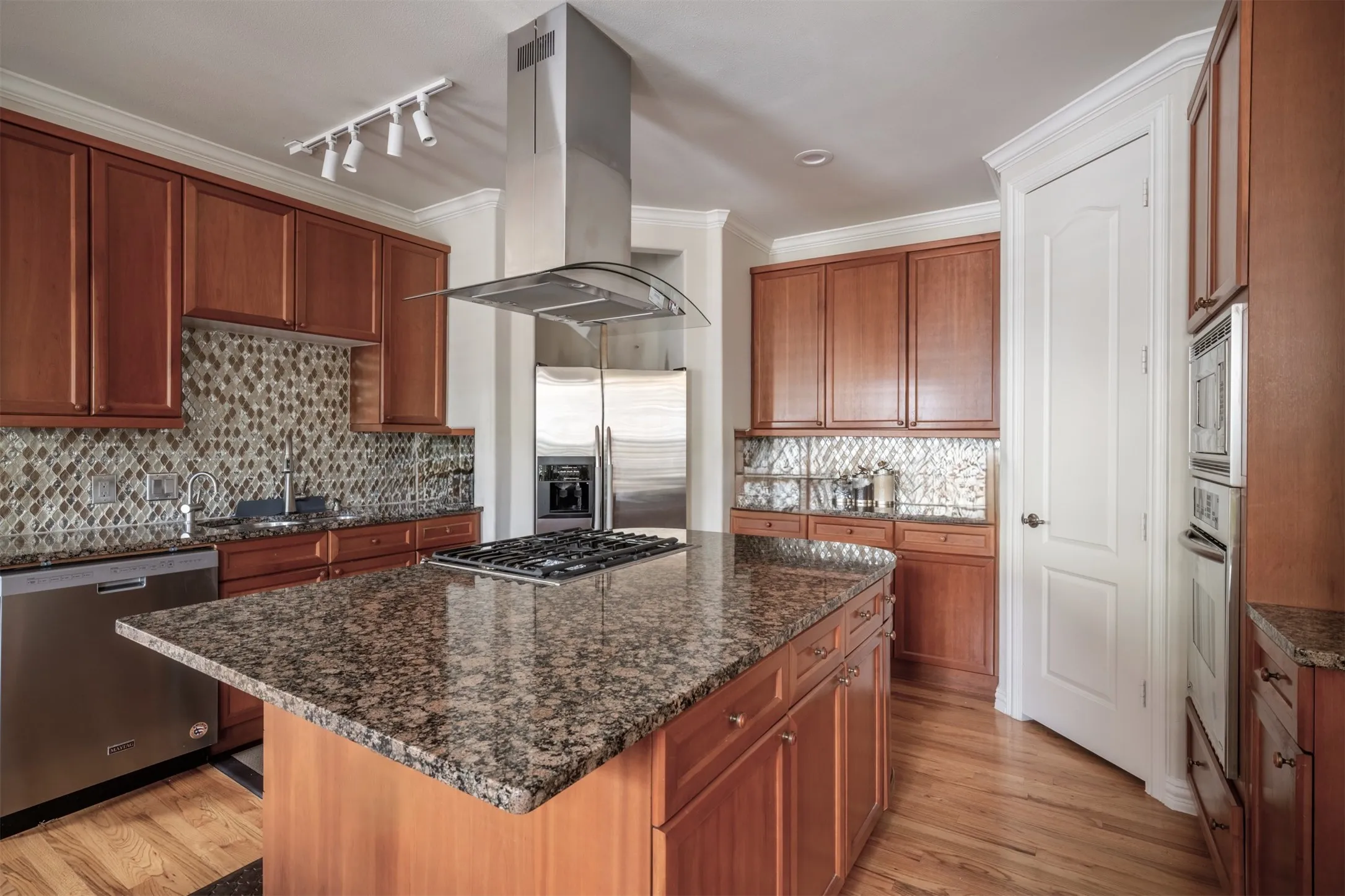 Kitchen with Custom Backsplash, Granite, equipped w Gas Cooktop and Two (2) Convection Ovens