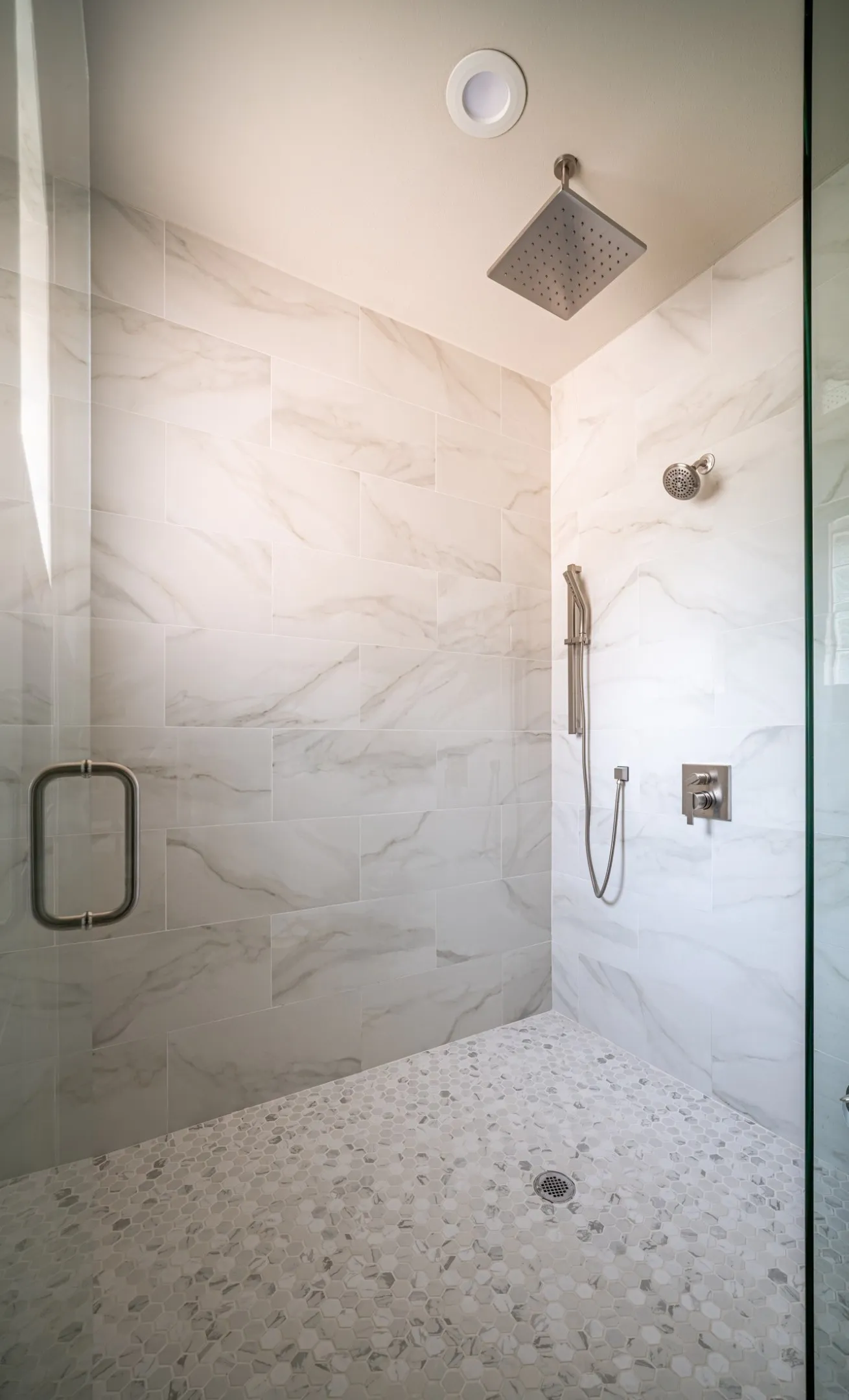 Oversized and Walk-In Primary Shower drenched in natural sunlight