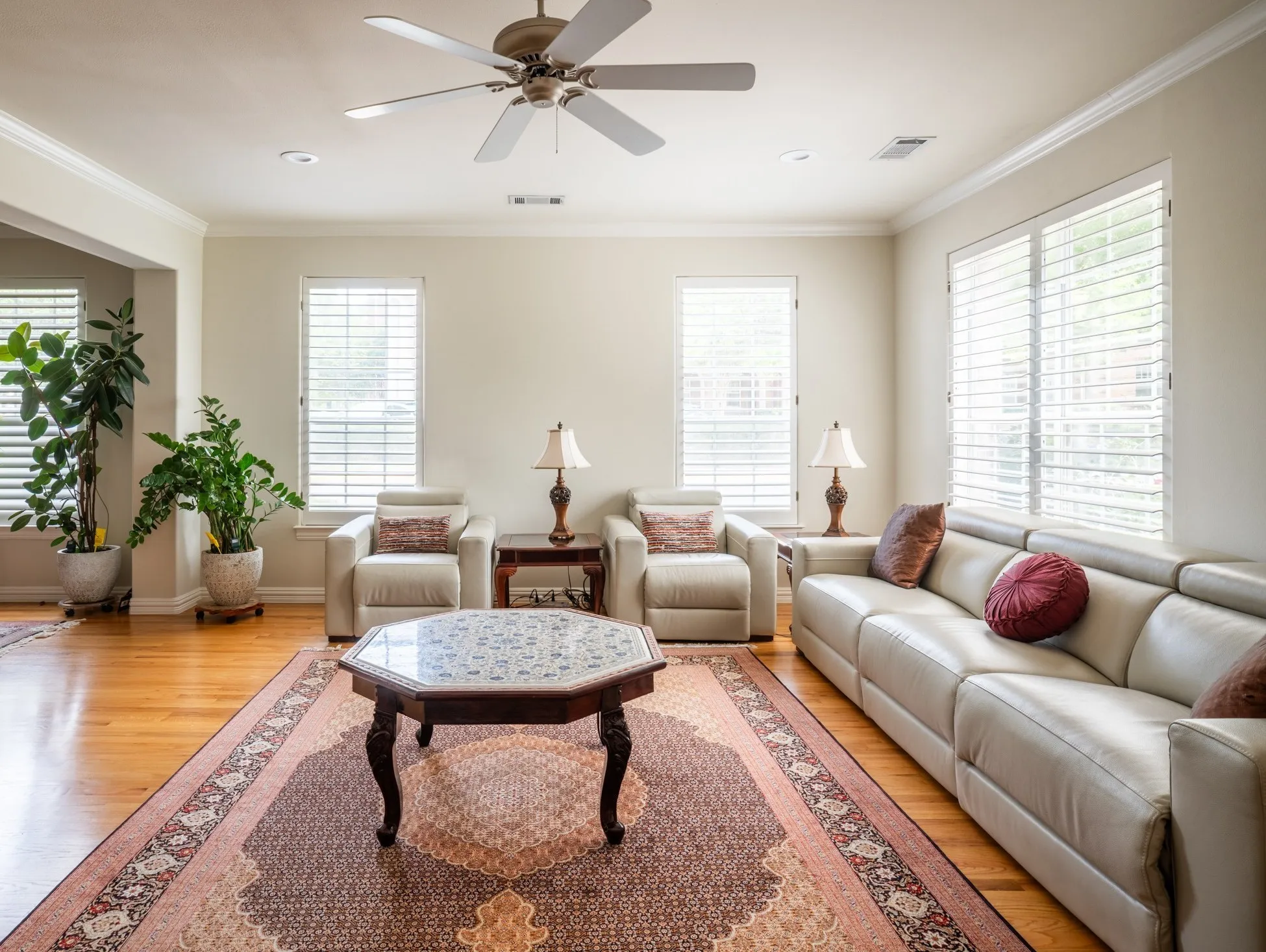 Living Room Radiant with ample Natural Lights, Custom Plantation Shutters, and cozy fireplace