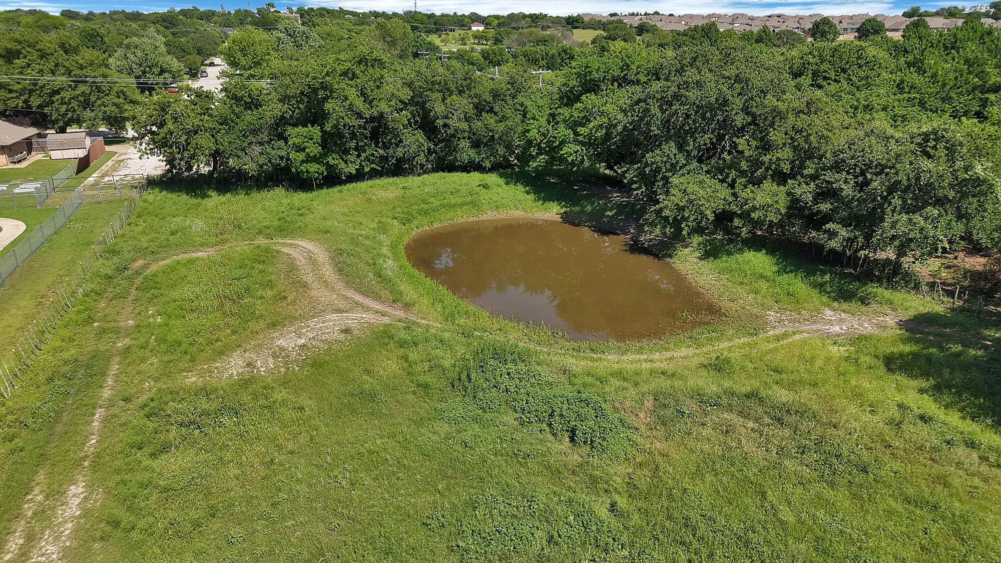 Tank in pasture behind arena
