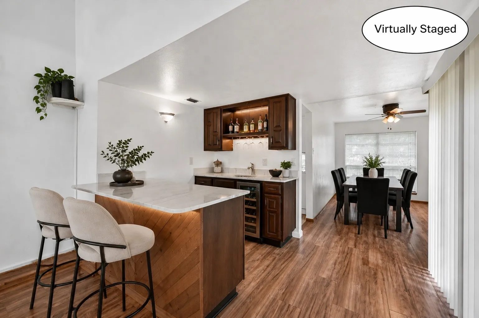 Enjoy entertaining at the wet bar with refrigerator. (Virtually Staged)