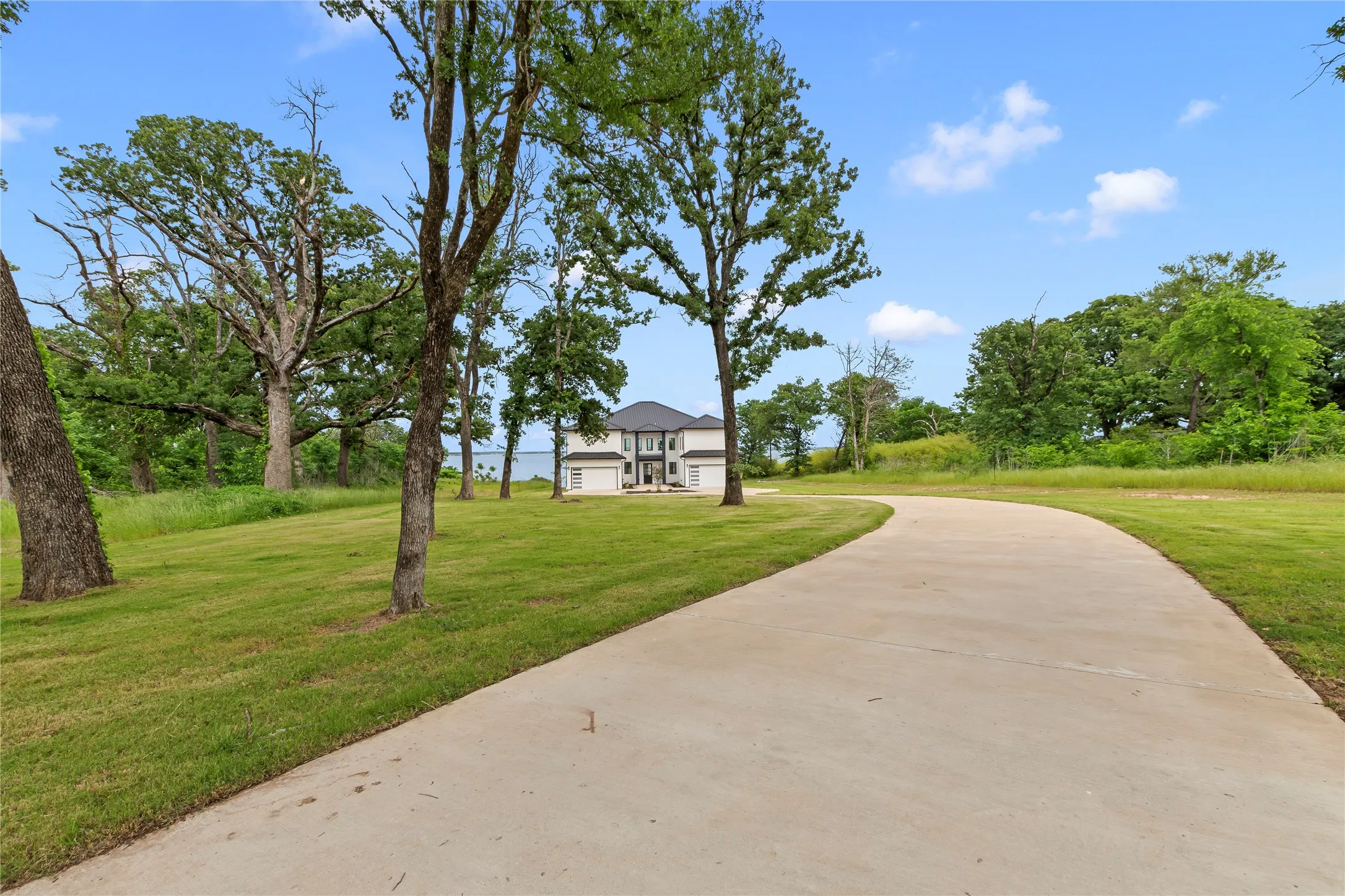 Set at the end of a cul-de-sac, a long winding drive leads to this architecturally distinct Cedar Creek Lake retreat.