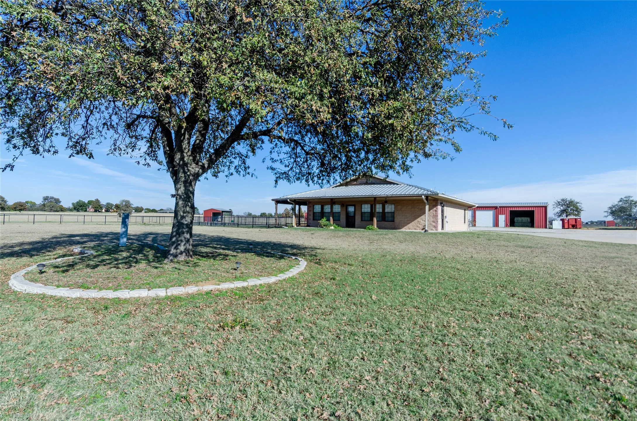 View of yard with a garage and an outbuilding