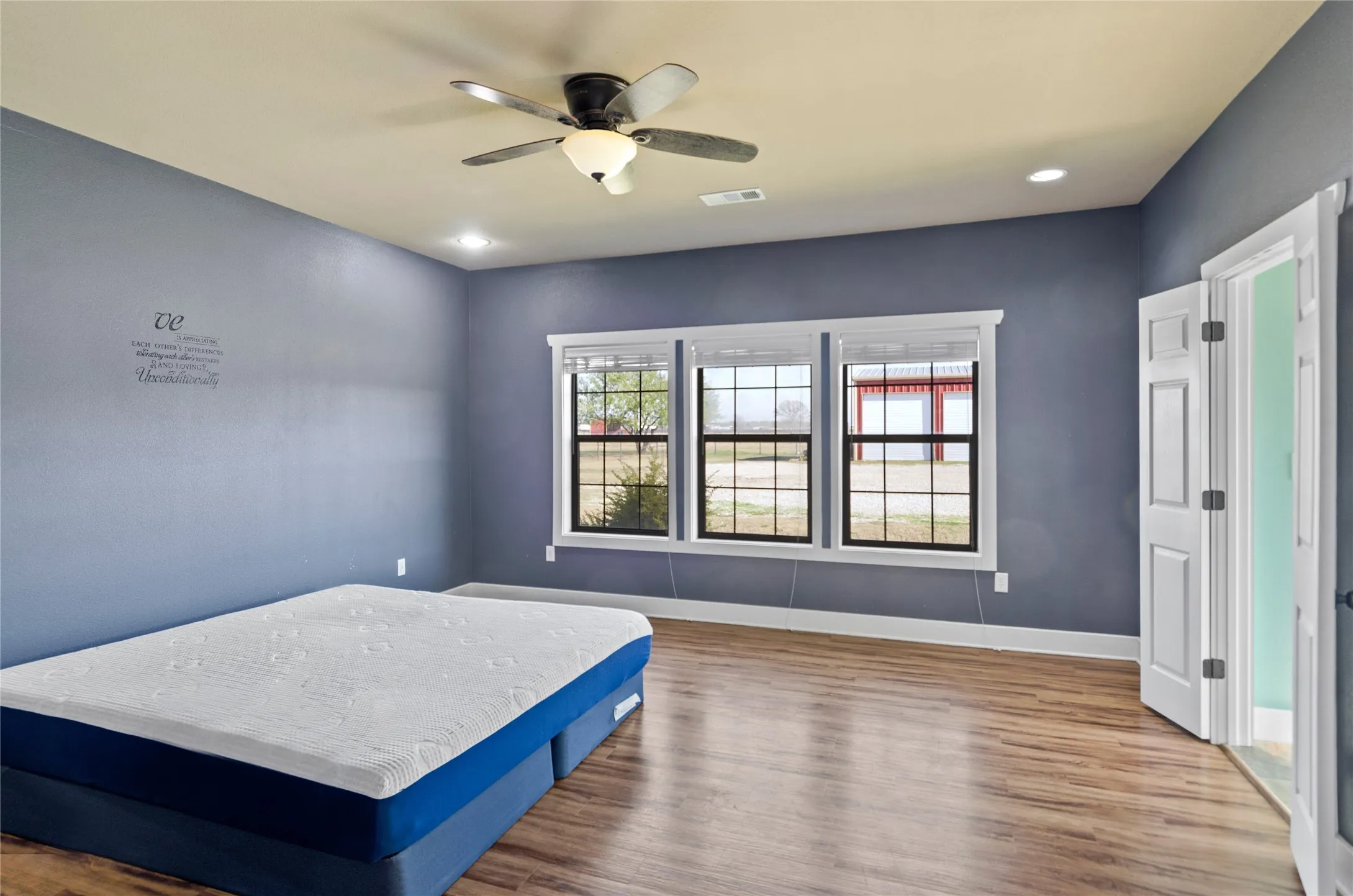 Bedroom featuring wood finished floors, ceiling fan, and recessed lighting