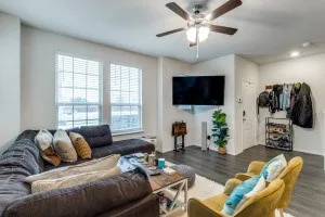 Living area with wood-finish flooring, recessed lighting, and a ceiling fan