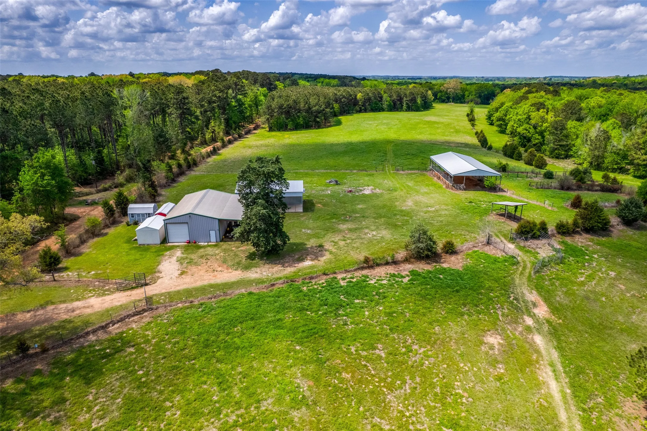 Aerial view of shop, second RV pad, Hay loft and 3 guest buildings.