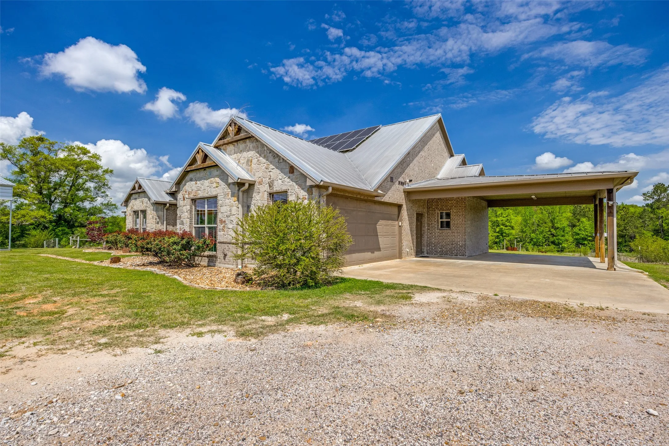 View of 36x40 carport and 2 car garage.