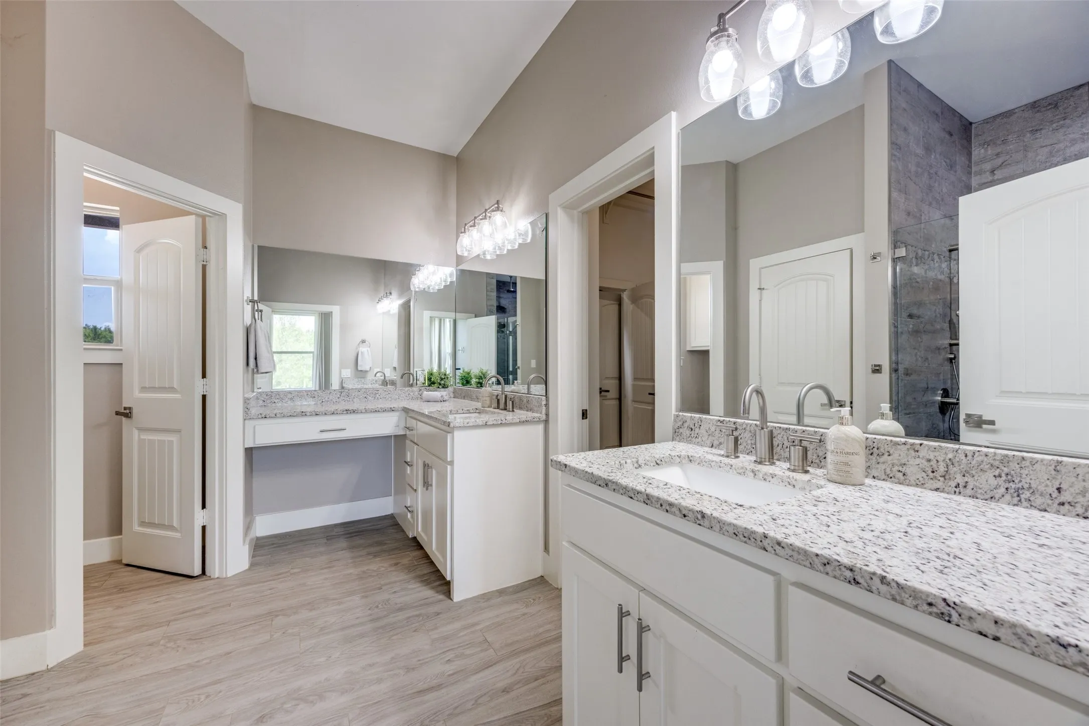 Primary bath with separate vanities.