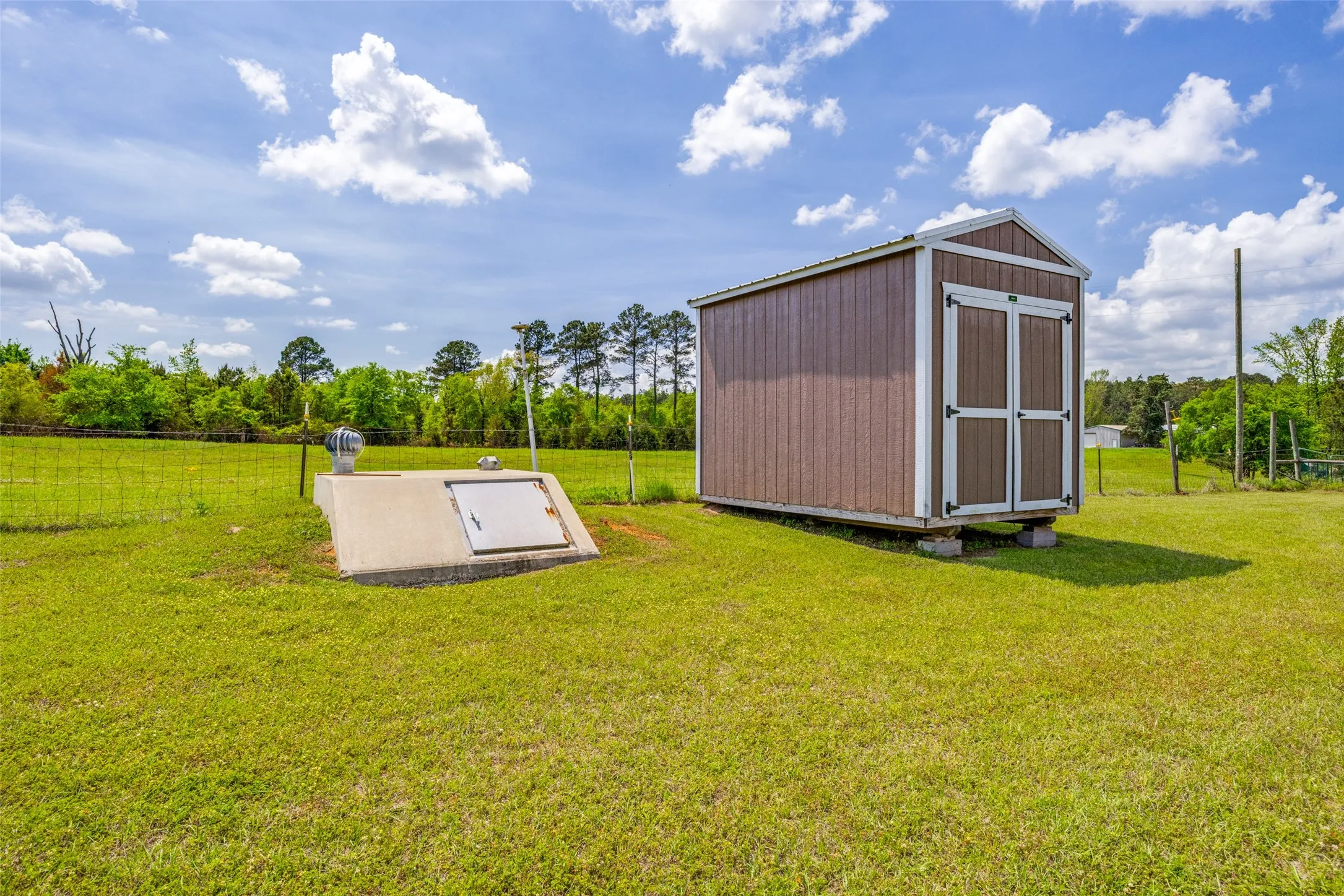 Storm shelter and additional storage shed.