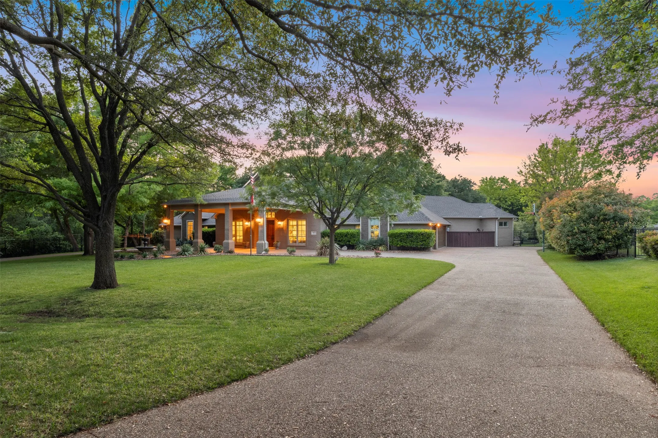 long driveway leading to porte cochere and 3 car garage