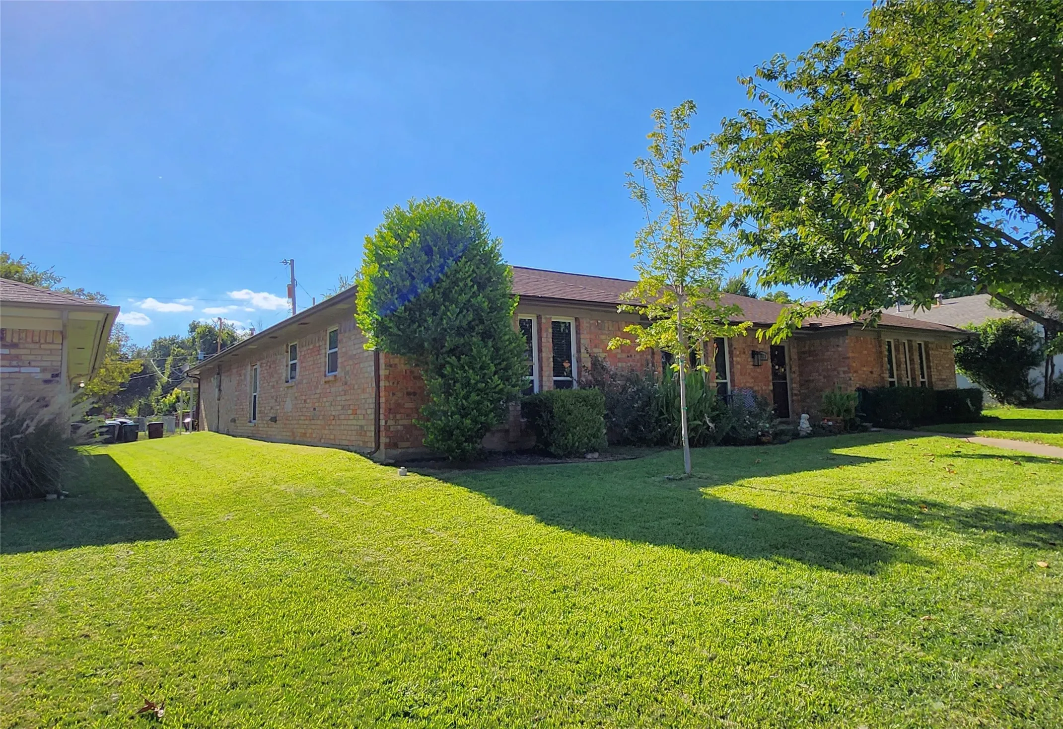 Brick exterior with a brown shingle roof