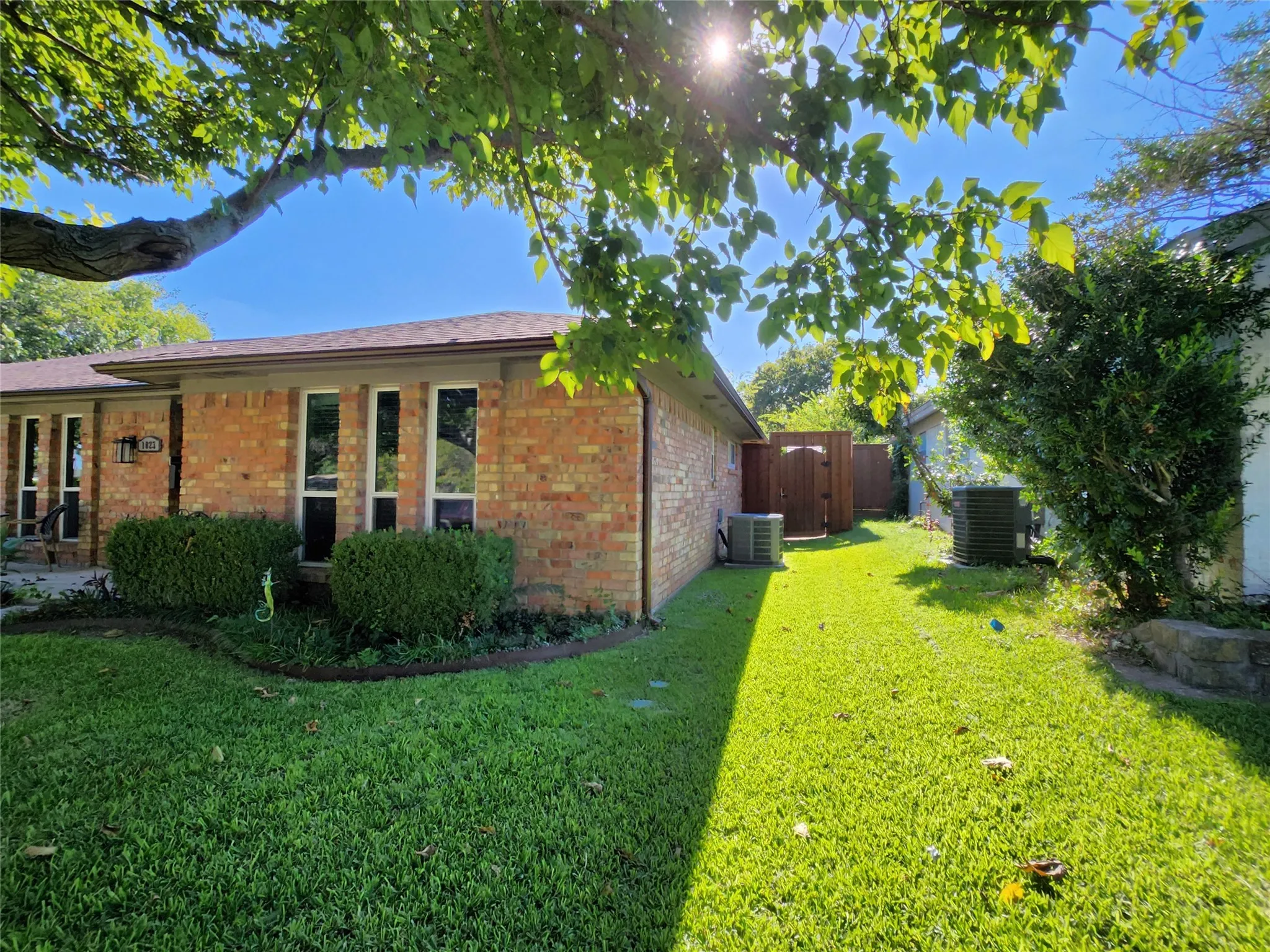 Brick exterior featuring multiple tall windows with white framing