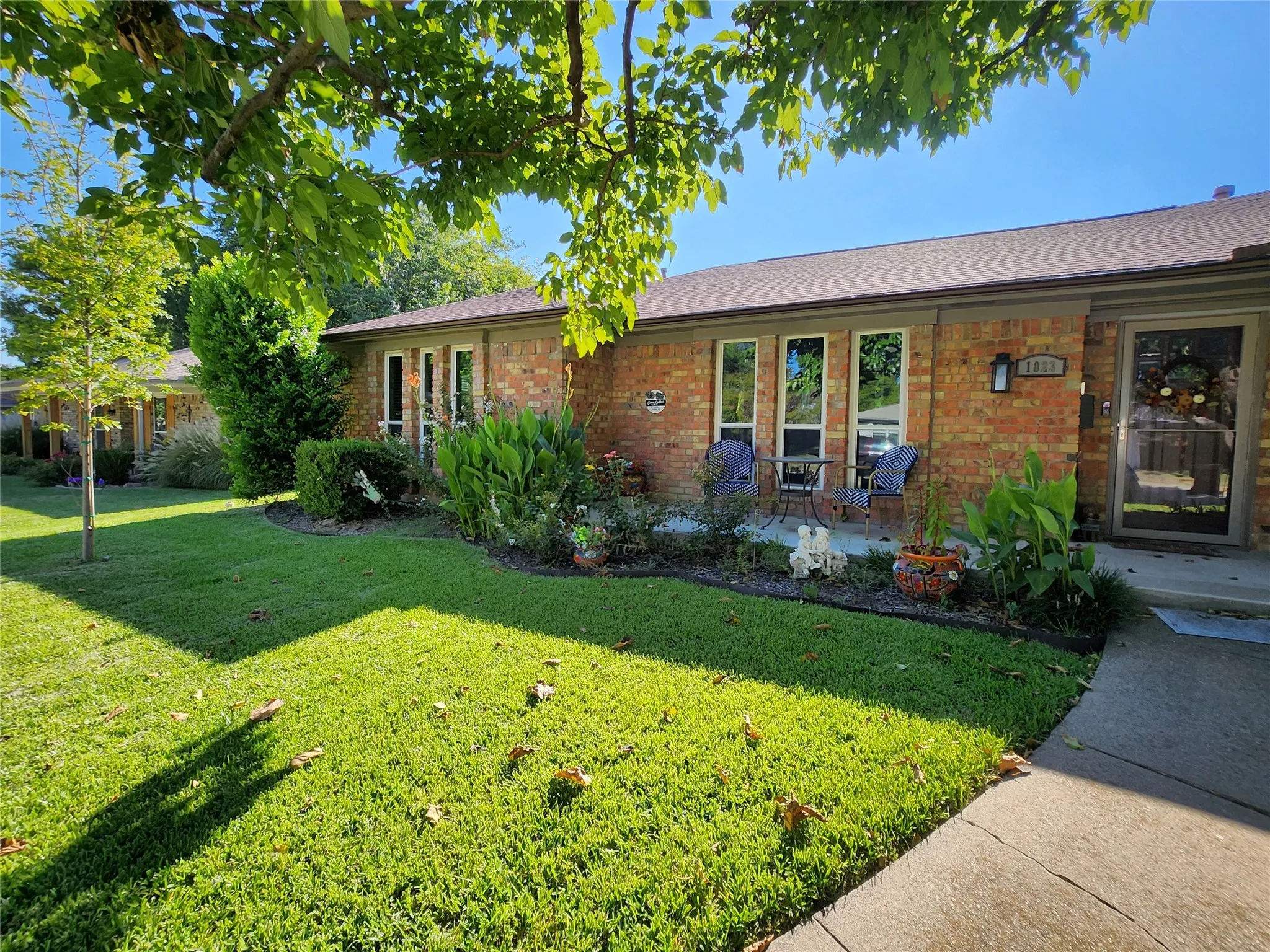 Brick exterior with a brown shingle roof