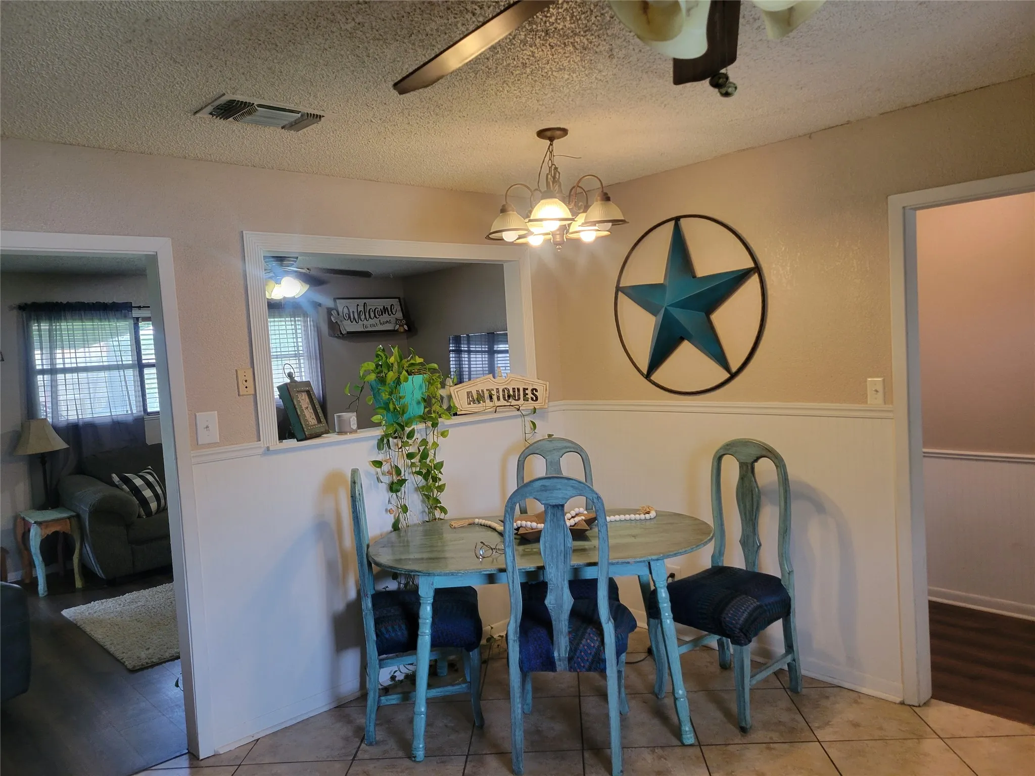 Dining area with tile flooring and wainscoting details
