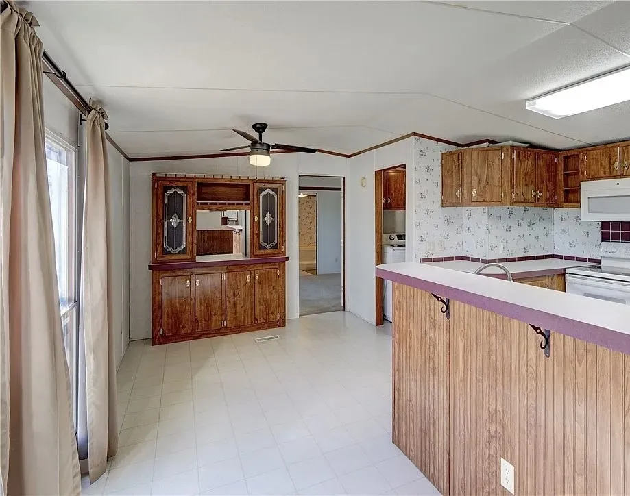 Open kitchen and dining area with tile-look flooring