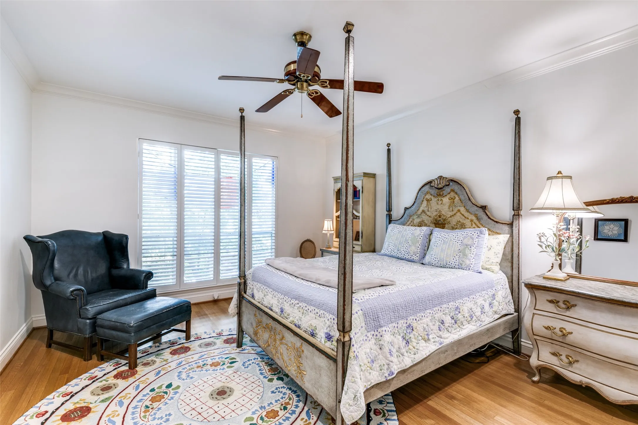Generous second bedroom with wood floors and plantation shutters.