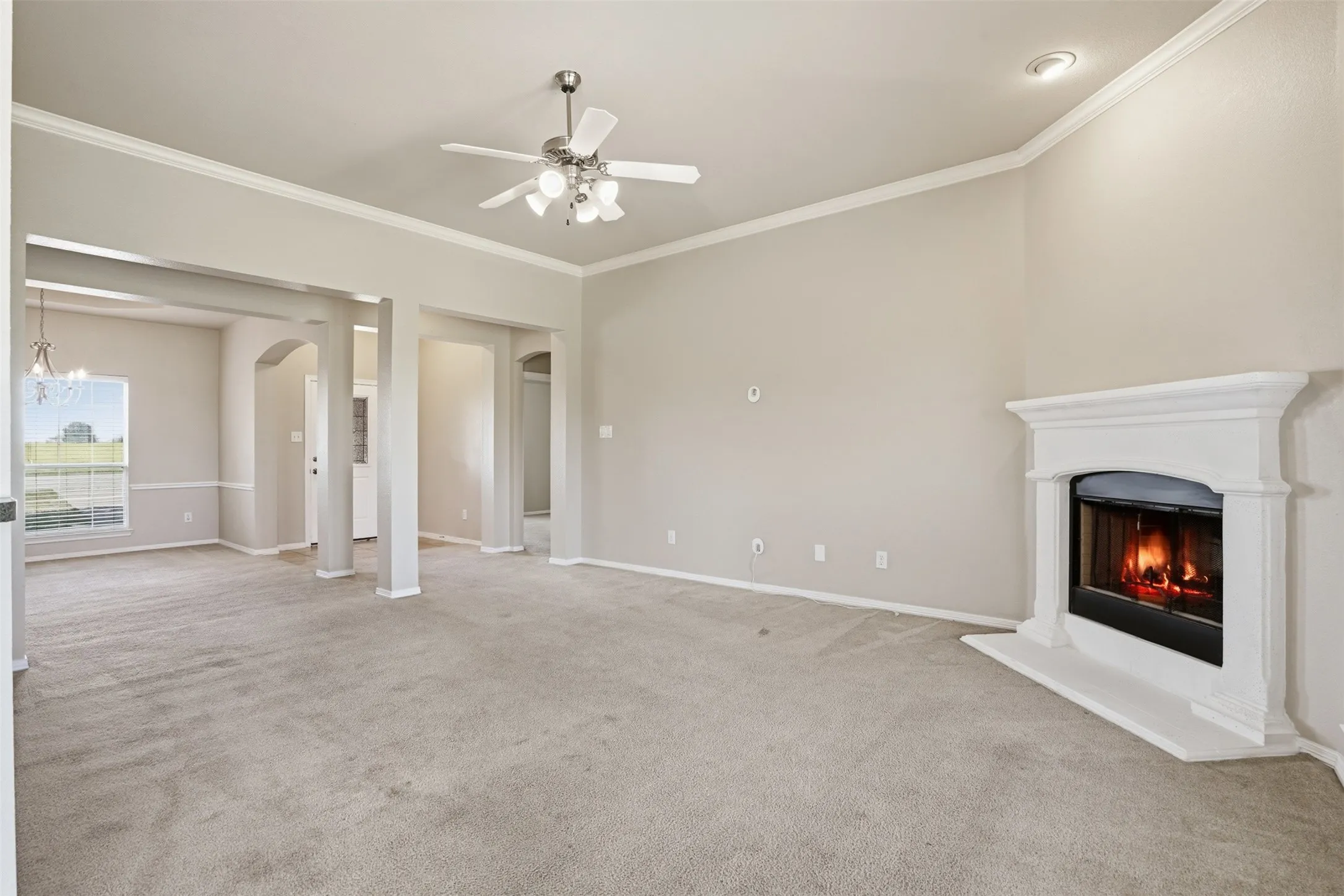 Living room with fireplace that opens to formal dining area.