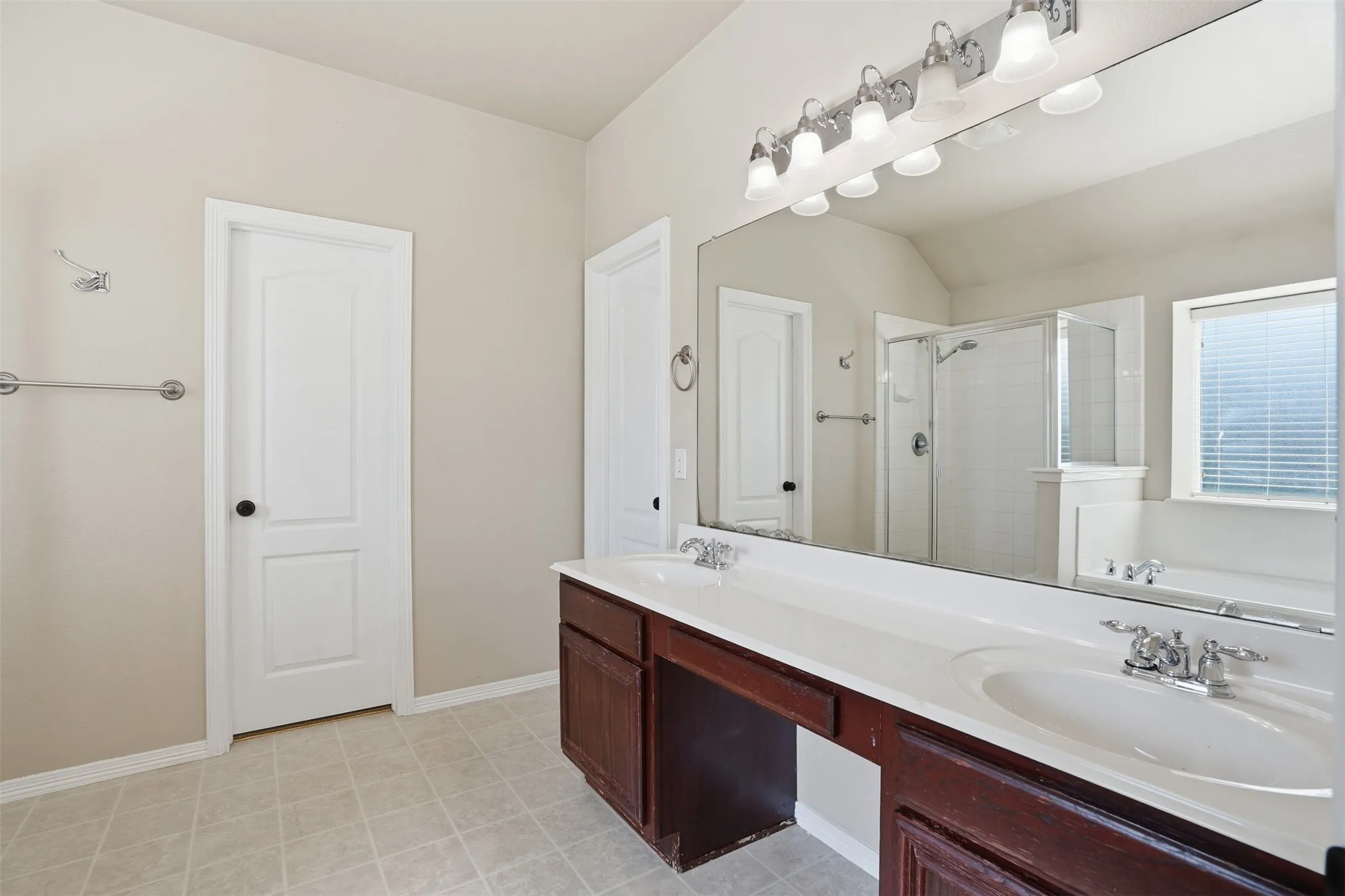 Primary bathroom with dual vanity, soaking tub and separate shower.
