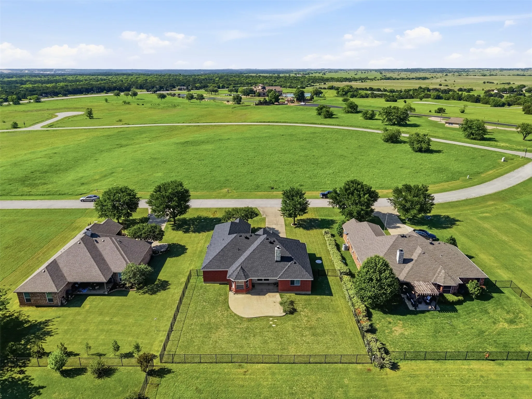 Aerial view of rear of property and the ample green space out front of the home.