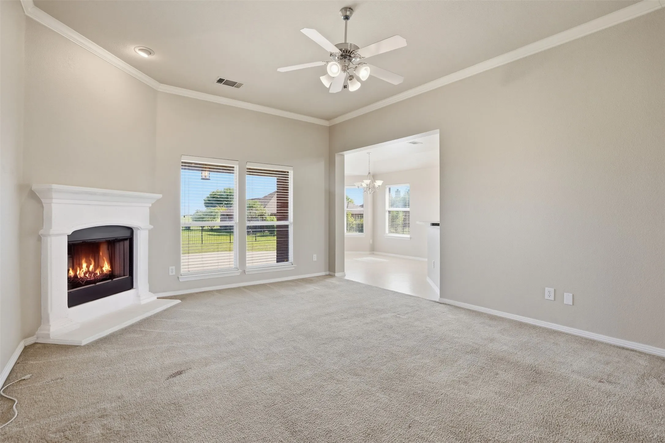 Living room with fireplace that connects seamlessly to the galley kitchen.
