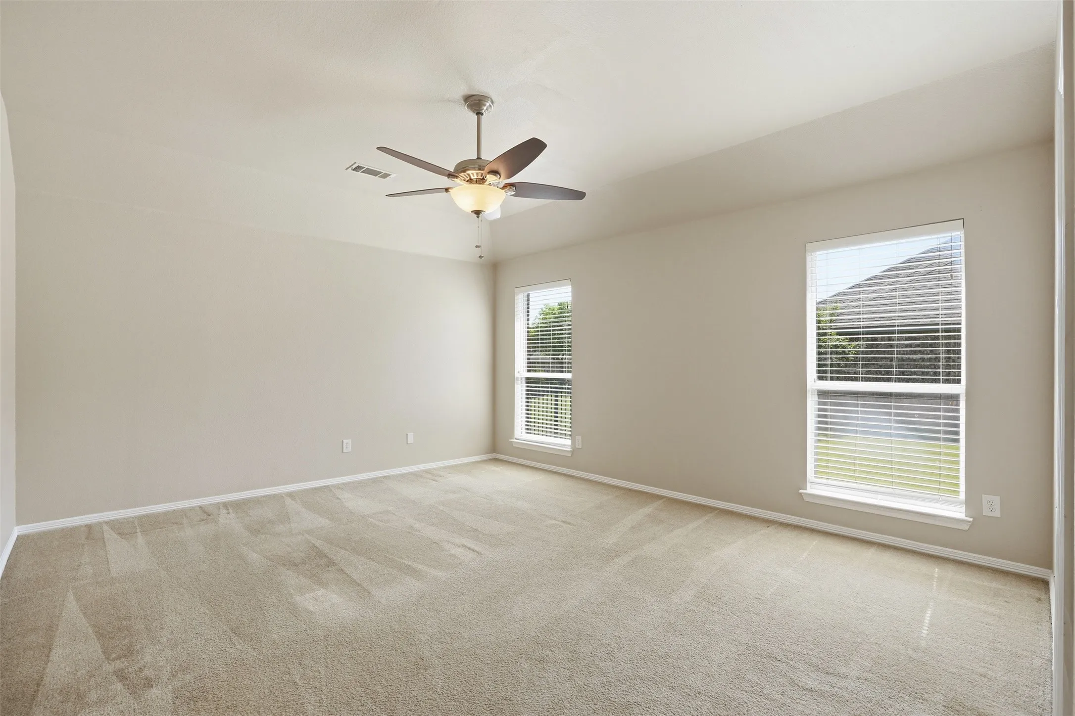 Spacious primary bedroom featuring featuring it's own ensuite bath.