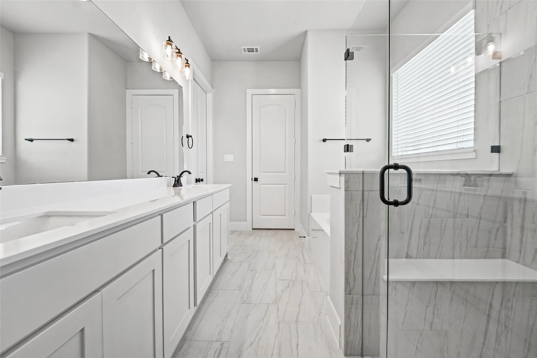 Dual vanity with undermount sinks, expansive mirror, and black fixtures