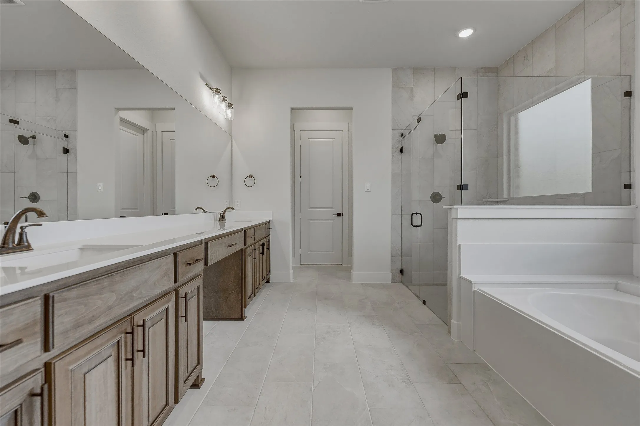 Dual vanity with undermount sinks, bronze-finish faucets, and white countertops