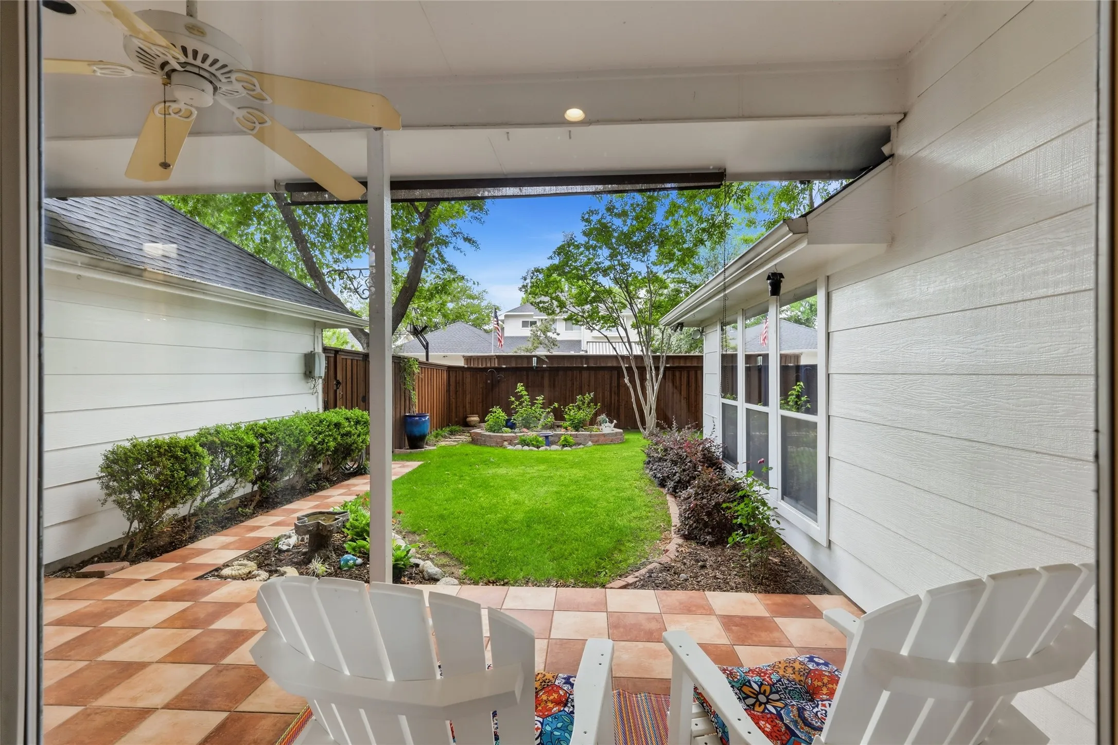 The backyard has a beautiful board on board fence, landscaping, and a peaceful covered back patio!