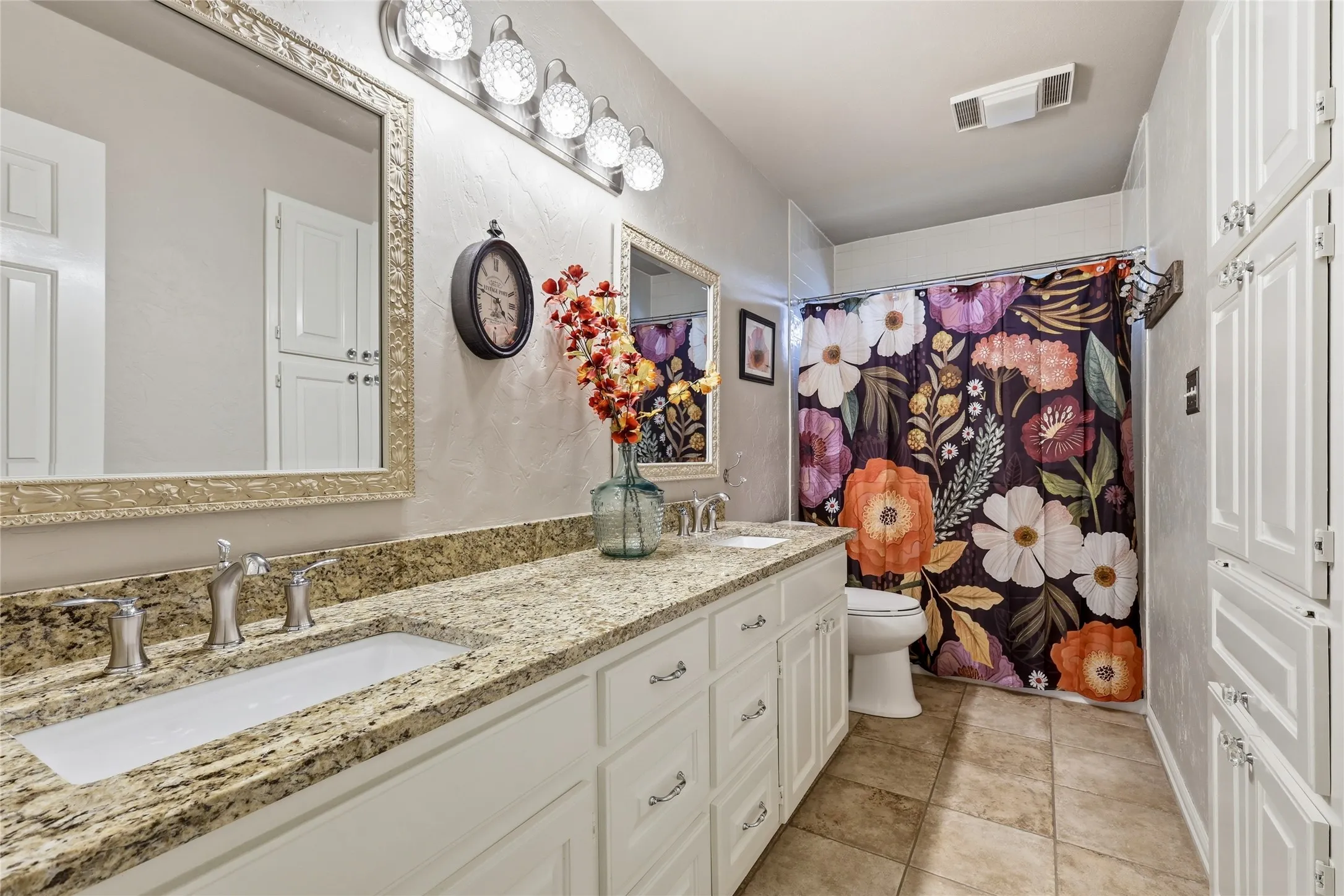 Upstairs bathroom has been updated with granite countertops and professionally painted cabinetry.