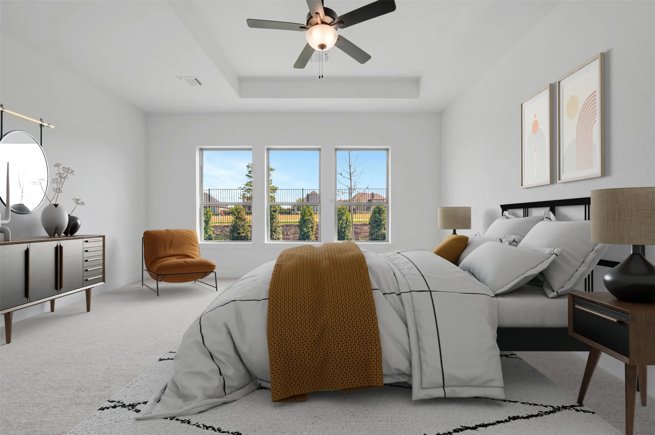 Recessed ceiling detail, three large windows, ceiling fan with integrated lighting, light-toned carpet flooring, white wall finishes