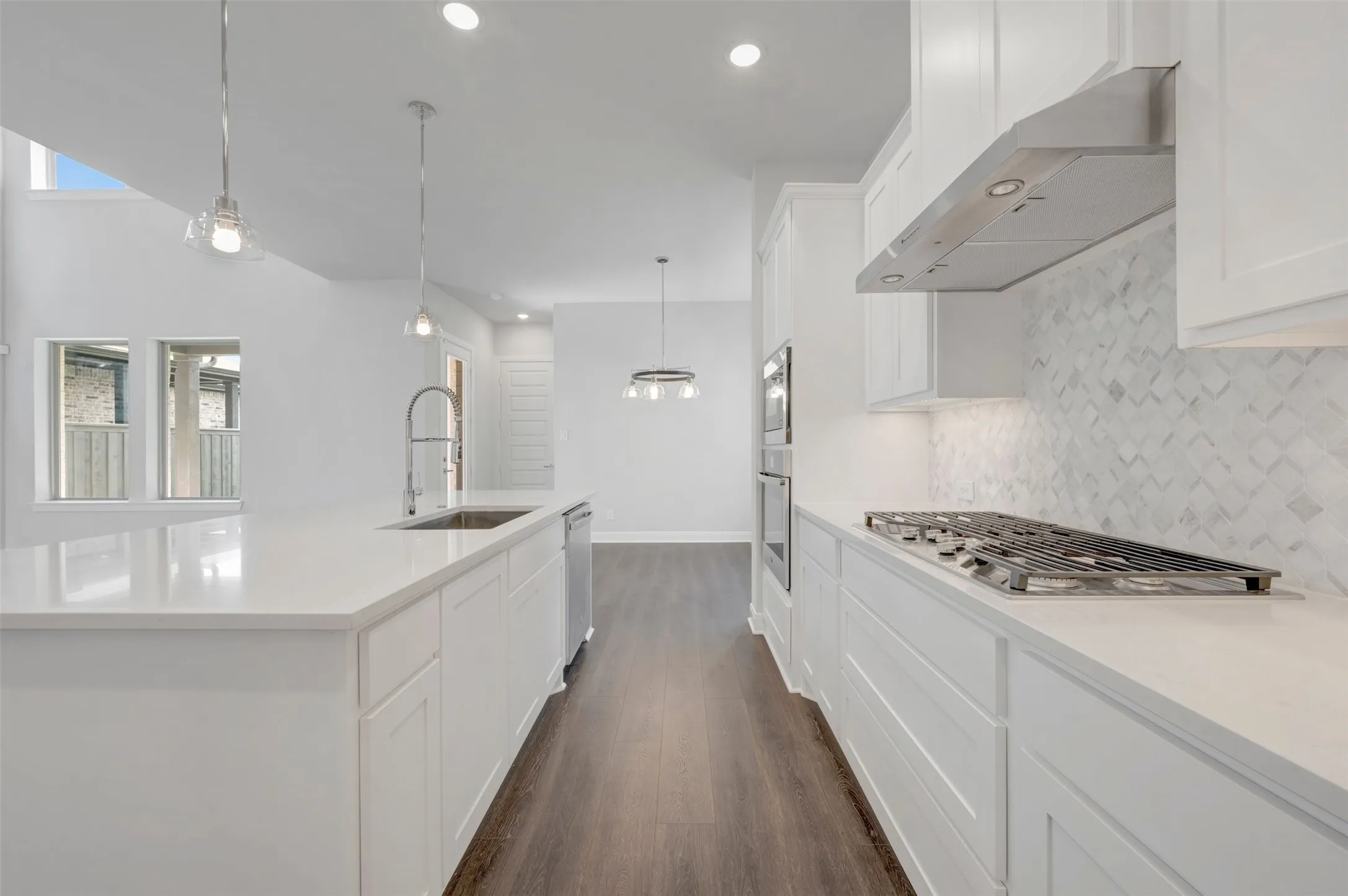 Modern kitchen featuring a gas range, stainless steel appliances, and a diagonal tile backsplash