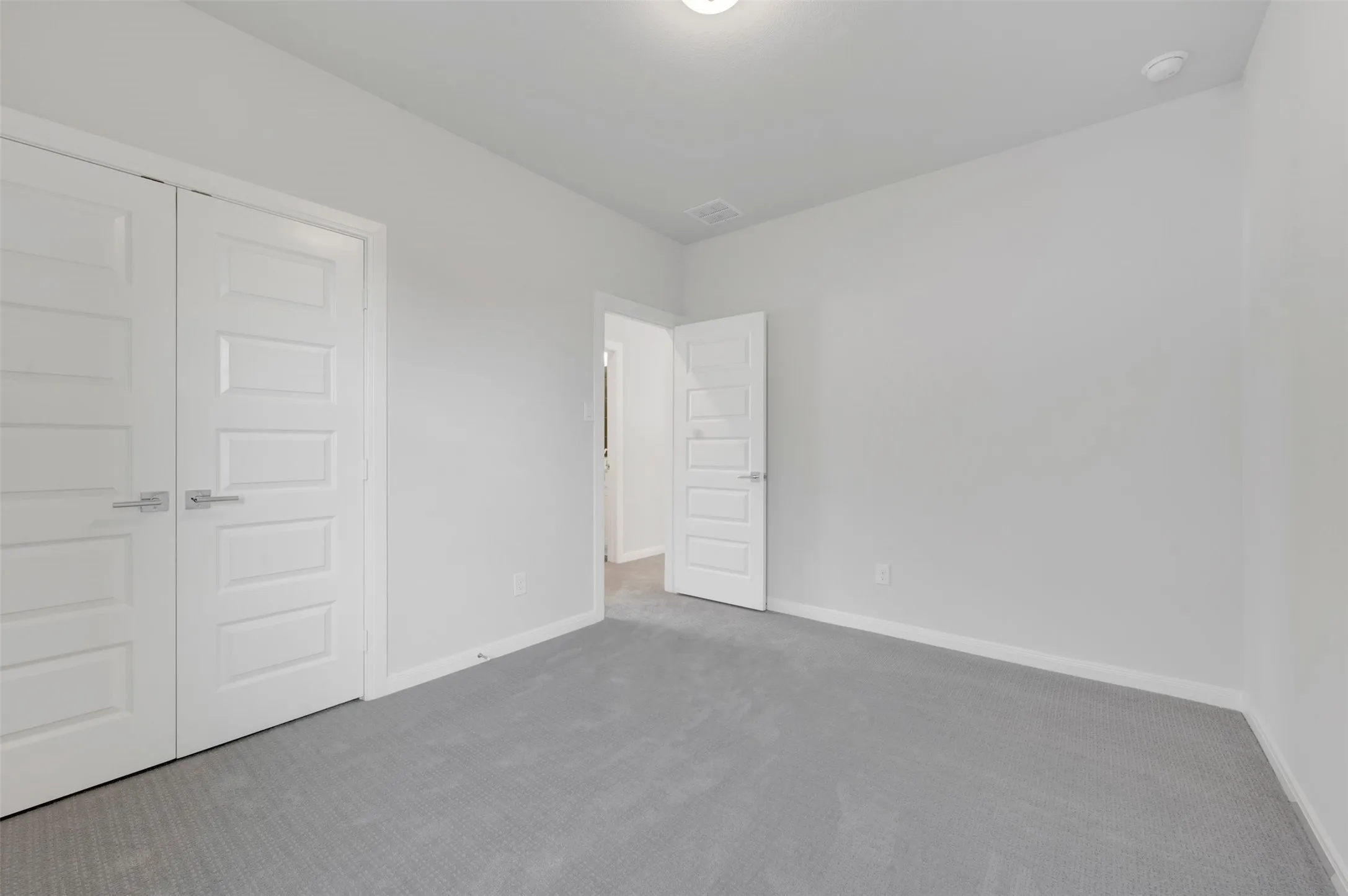 Neutral gray carpeting complements freshly painted light gray walls