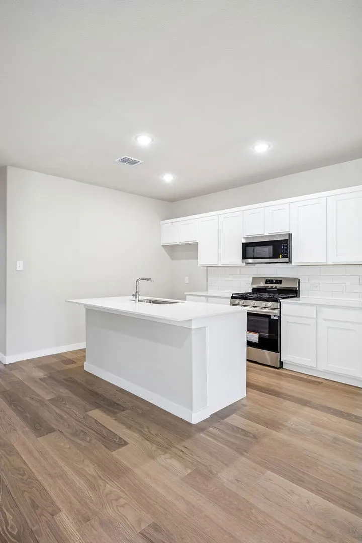 Kitchen in the Willow home plan by Trophy Signature Homes – REPRESENTATIVE PHOTO
