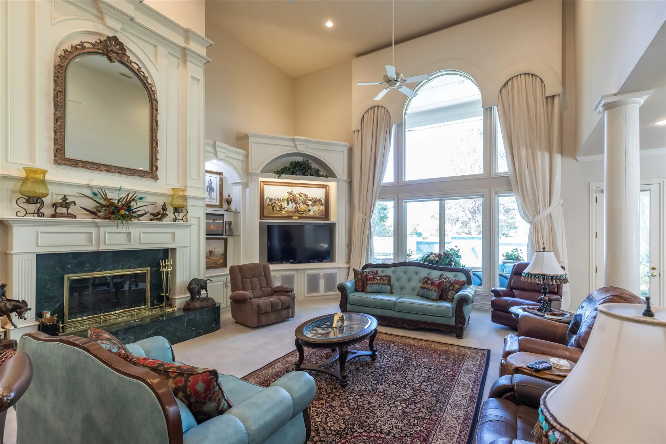 Floor to ceiling windows capture lots of natural light overlooking the golf course. Remote operated electric shades.