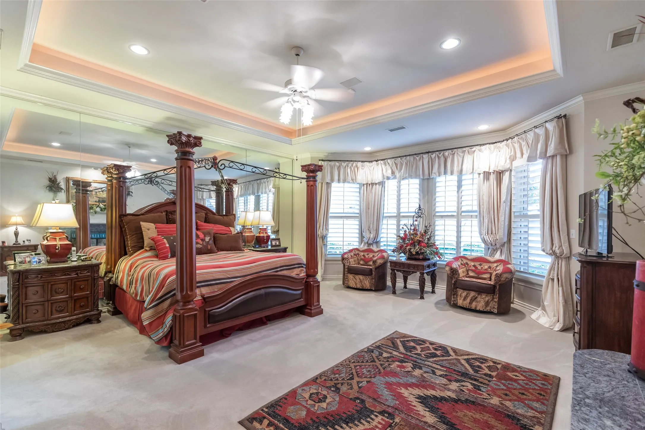 Oversized master bedroom retreat overlooking golf course.  Custom lighting and fireplace.  Plantation shutters.