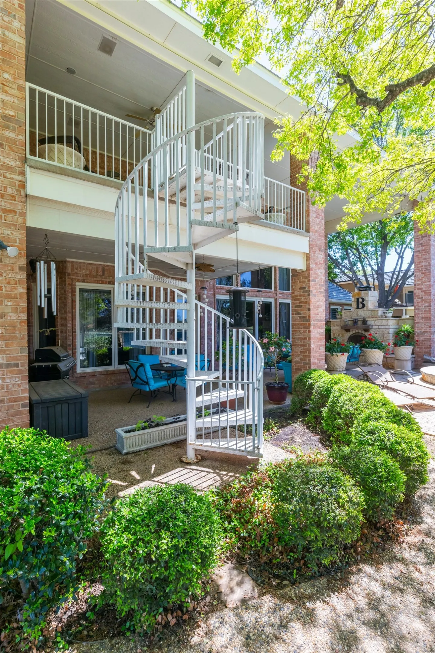 Spiral staircase leading to upstairs balcony overlooking golf course.