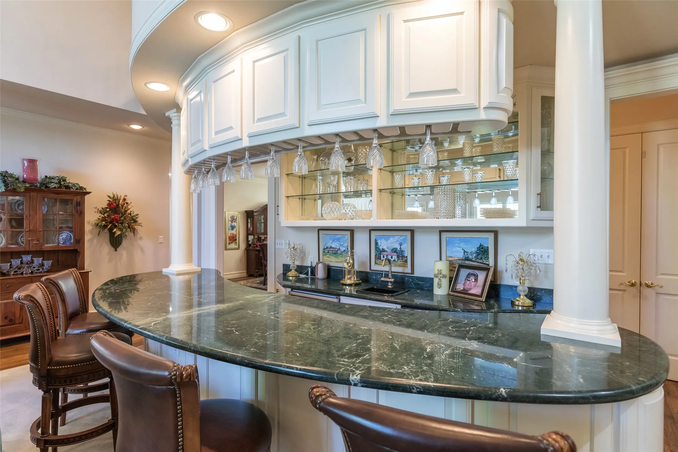 Large wet bar with ice maker, wine cooler, and lots of cabinetry.