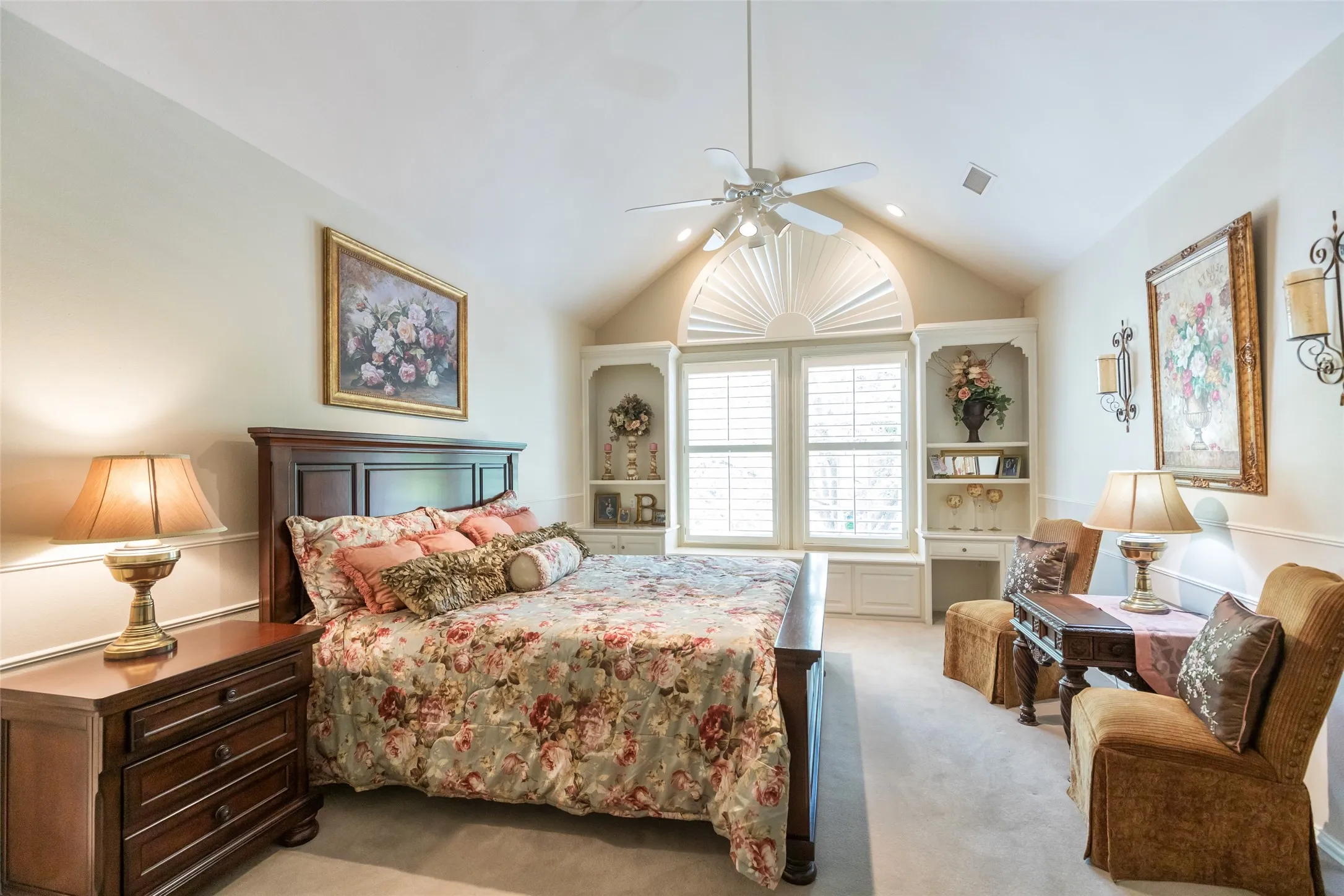 Upstairs bedroom with built in desk, window seat and plantation shutters.  Vaulted ceilings and private en suite bath.